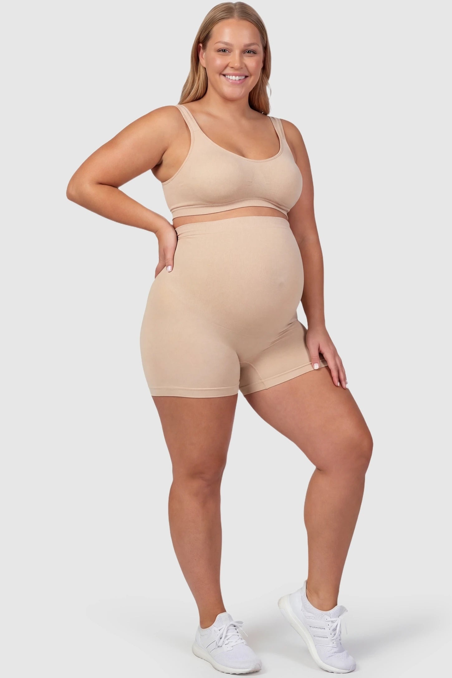 Over Bump Seamless Maternity Shapewear Shorts Over Bump Seamless Maternity Shapewear Shorts in Beige featuring a high-waist support panel in a front view on a plus size pregnant model.