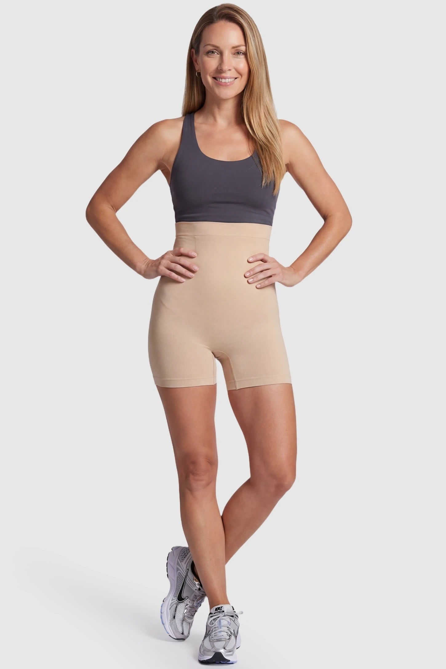 Over Bump Seamless Maternity Shapewear Shorts Over Bump Seamless Maternity Shapewear Shorts in Beige featuring gentle abdominal compression in a front view on a postpartum model.