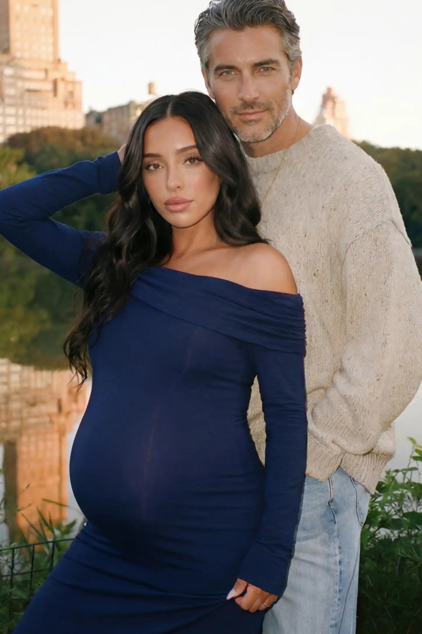 Solid Off Shoulder Bodycon Maternity Maxi Dress Off Shoulder Bodycon Maternity Maxi Dress in Blue featuring a smooth stretch finish on a pregnant model posing with a partner.