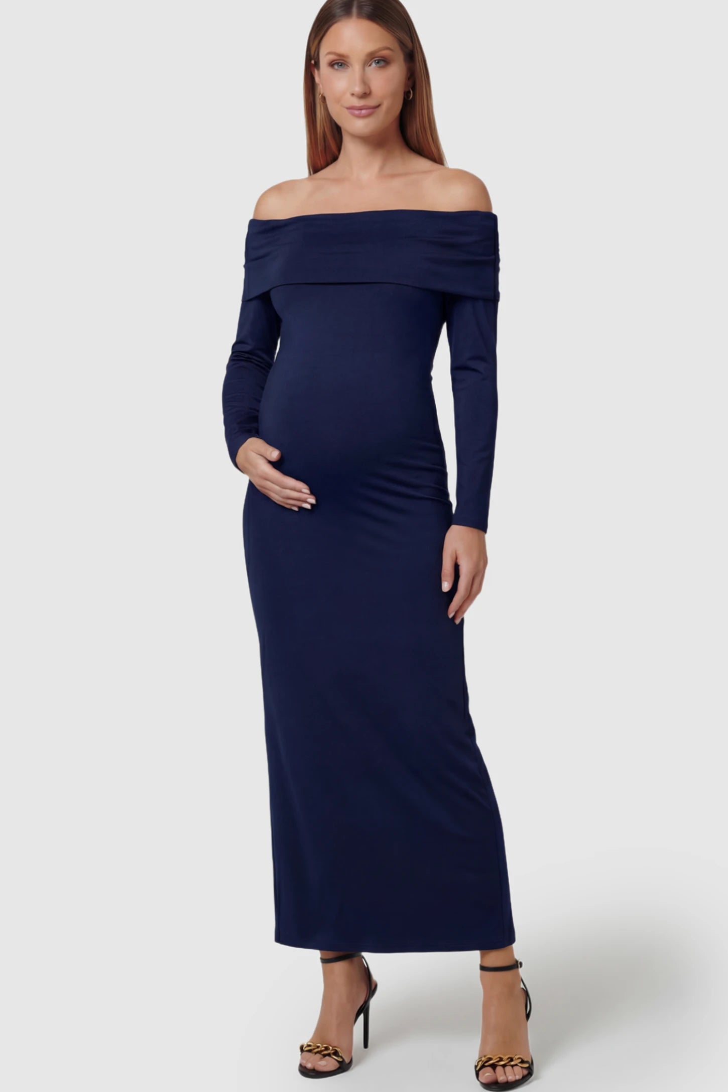 Solid Off Shoulder Bodycon Maternity Maxi Dress Off Shoulder Bodycon Maternity Maxi Dress in blue featuring a smooth stretch finish on a pregnant model showing front.