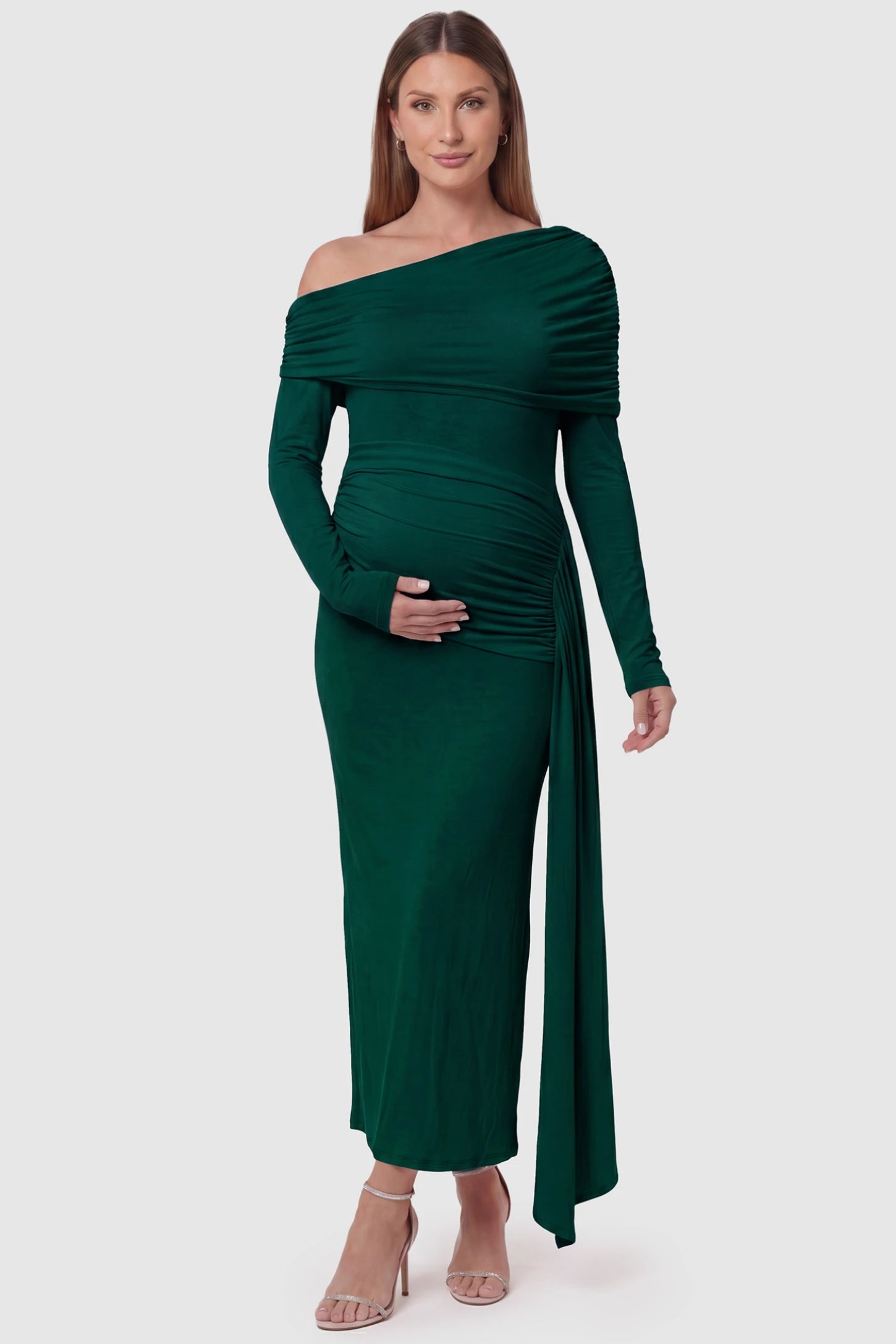 Off Shoulder Draped Wrap Bodycon Maternity Maxi Dress Off Shoulder Draped Wrap Bodycon Maternity Maxi Dress in Green featuring side ruching and long sleeves on a pregnant model, front view.
