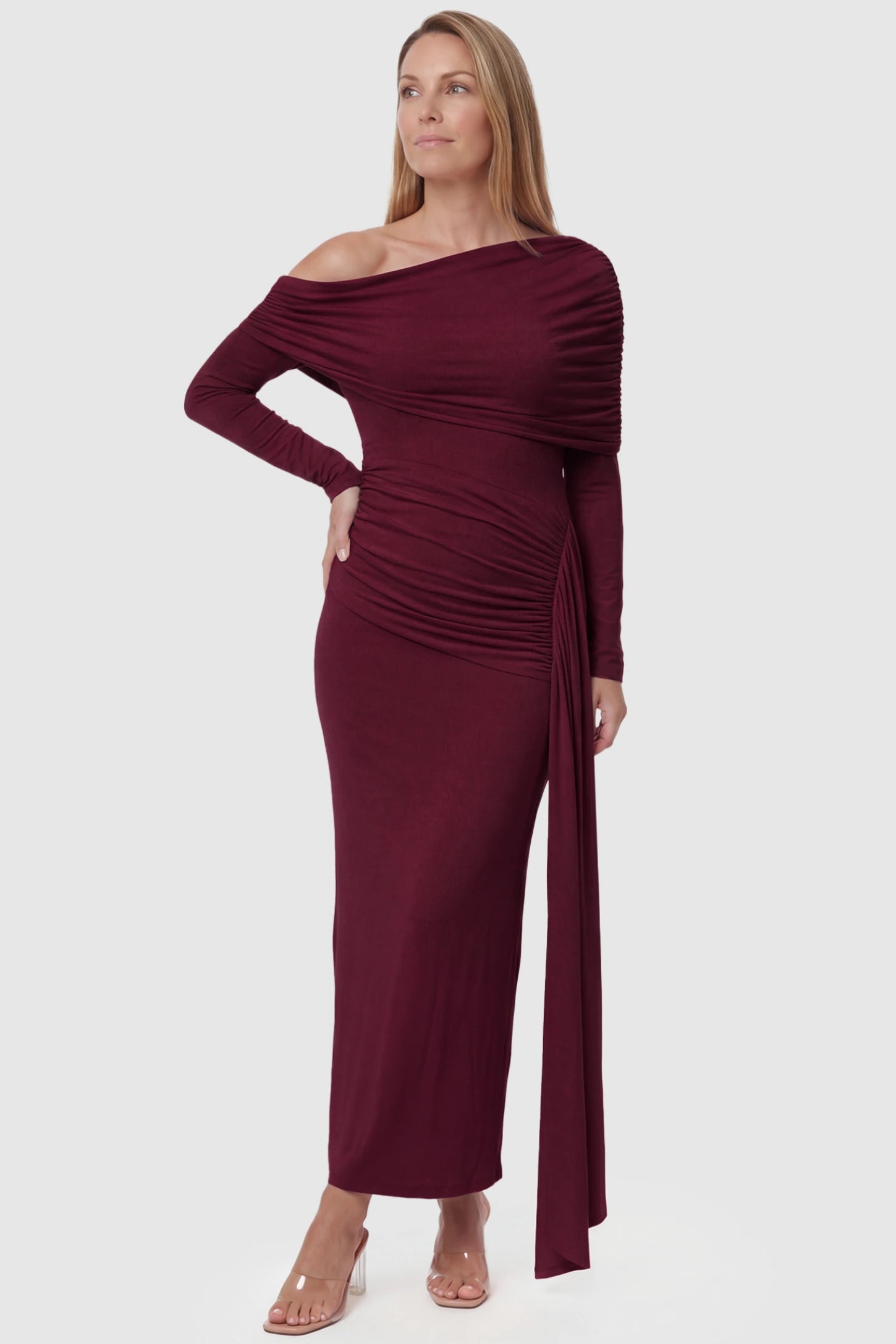 Off Shoulder Draped Wrap Bodycon Maternity Maxi Dress Off Shoulder Draped Wrap Bodycon Maternity Maxi Dress in Wine Red featuring side ruching and long sleeves on a postpartum model, front view.