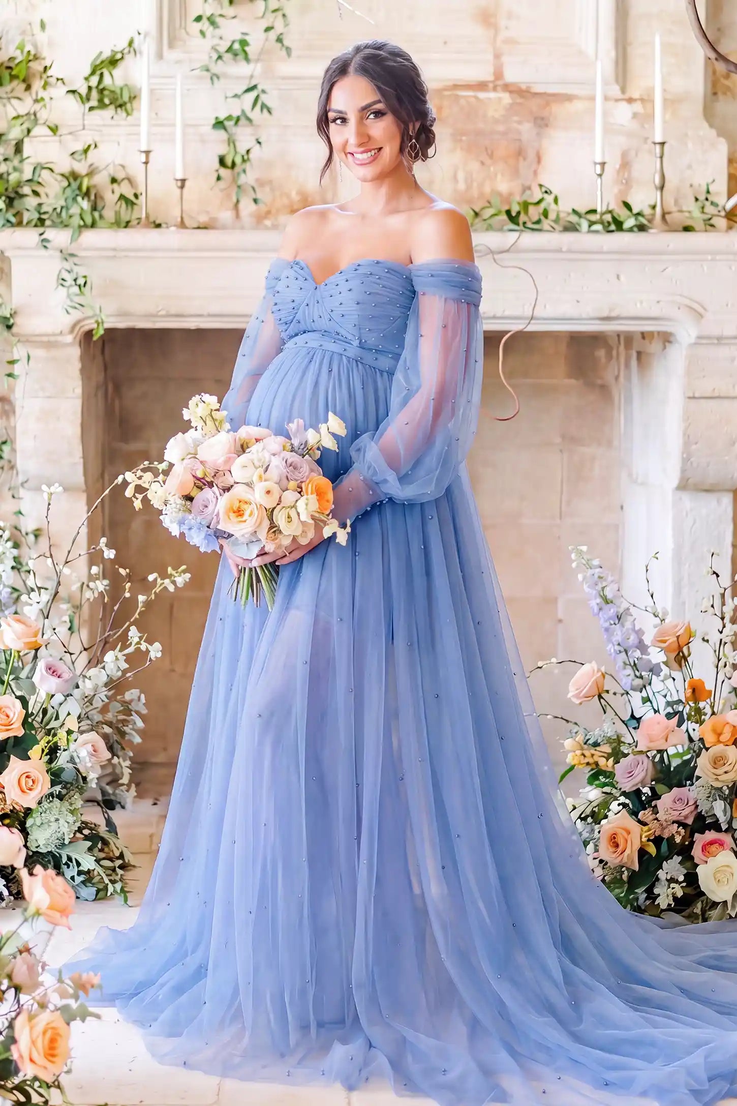 Off-Shoulder Empire Waist Maternity Gown in Blue featuring an off-shoulder sweetheart neckline, outdoor lifestyle front view on a pregnant model.