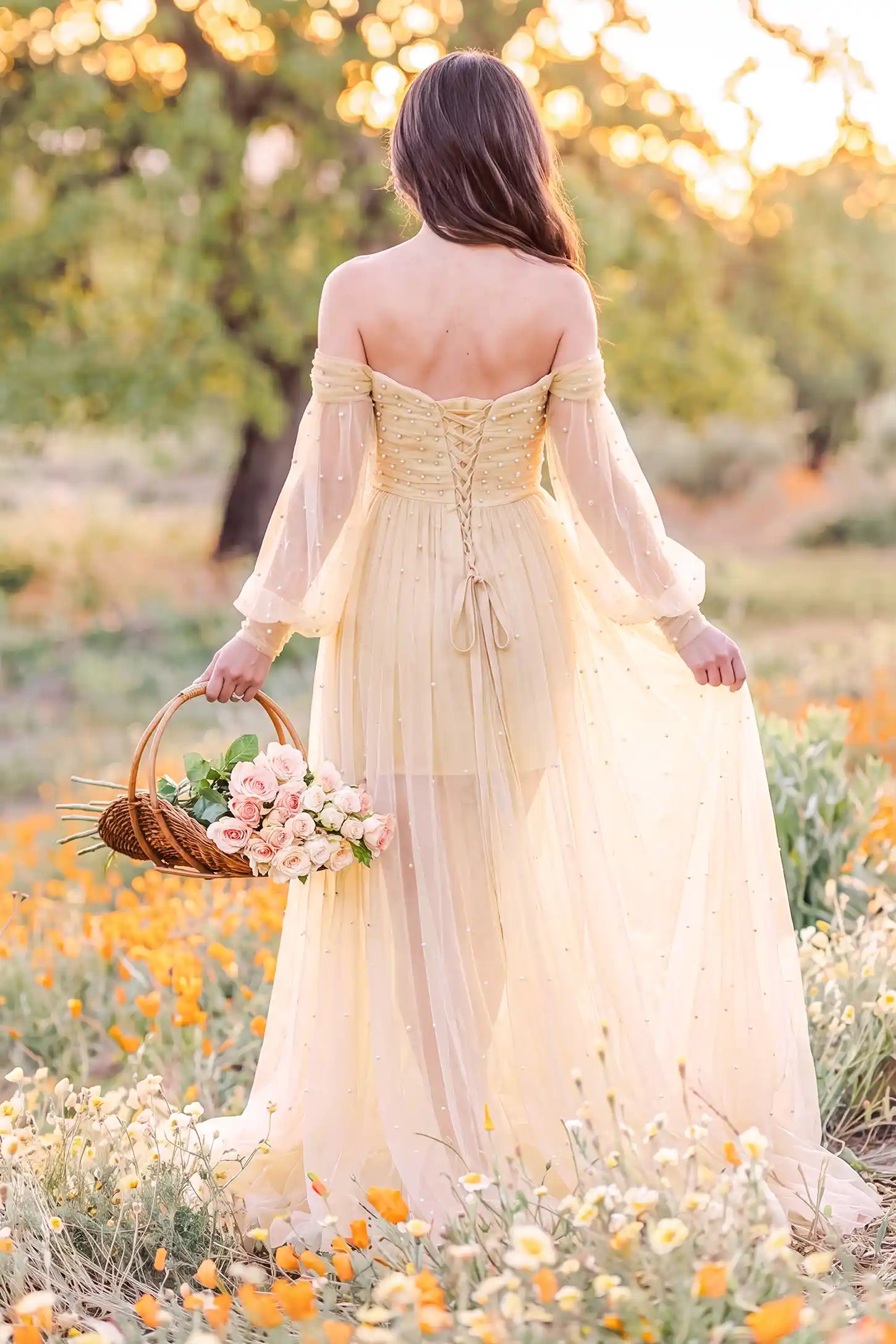 Off-Shoulder Empire Waist Tulle Maternity Gown Off-Shoulder Empire Waist Maternity Gown in Camel showcasing flowing tulle movement, outdoor lifestyle back view on a pregnant model.