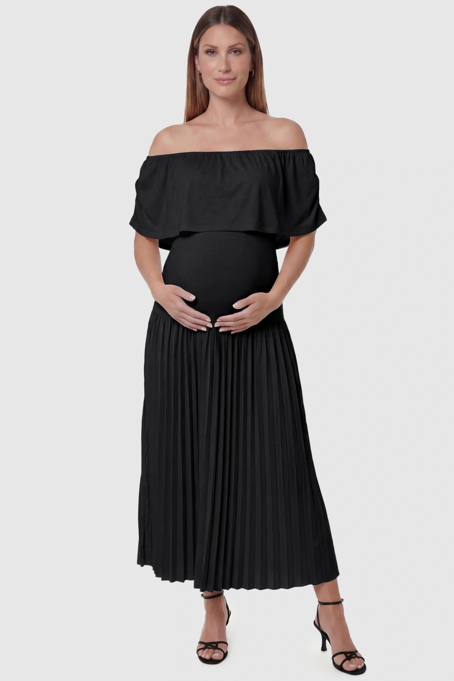 Pleated Off Shoulder Maternity Maxi Dress Pleated Off Shoulder Maternity Maxi Dress  in Black featuring a high stretch pleated maxi skirt on a pregnant model, front view.