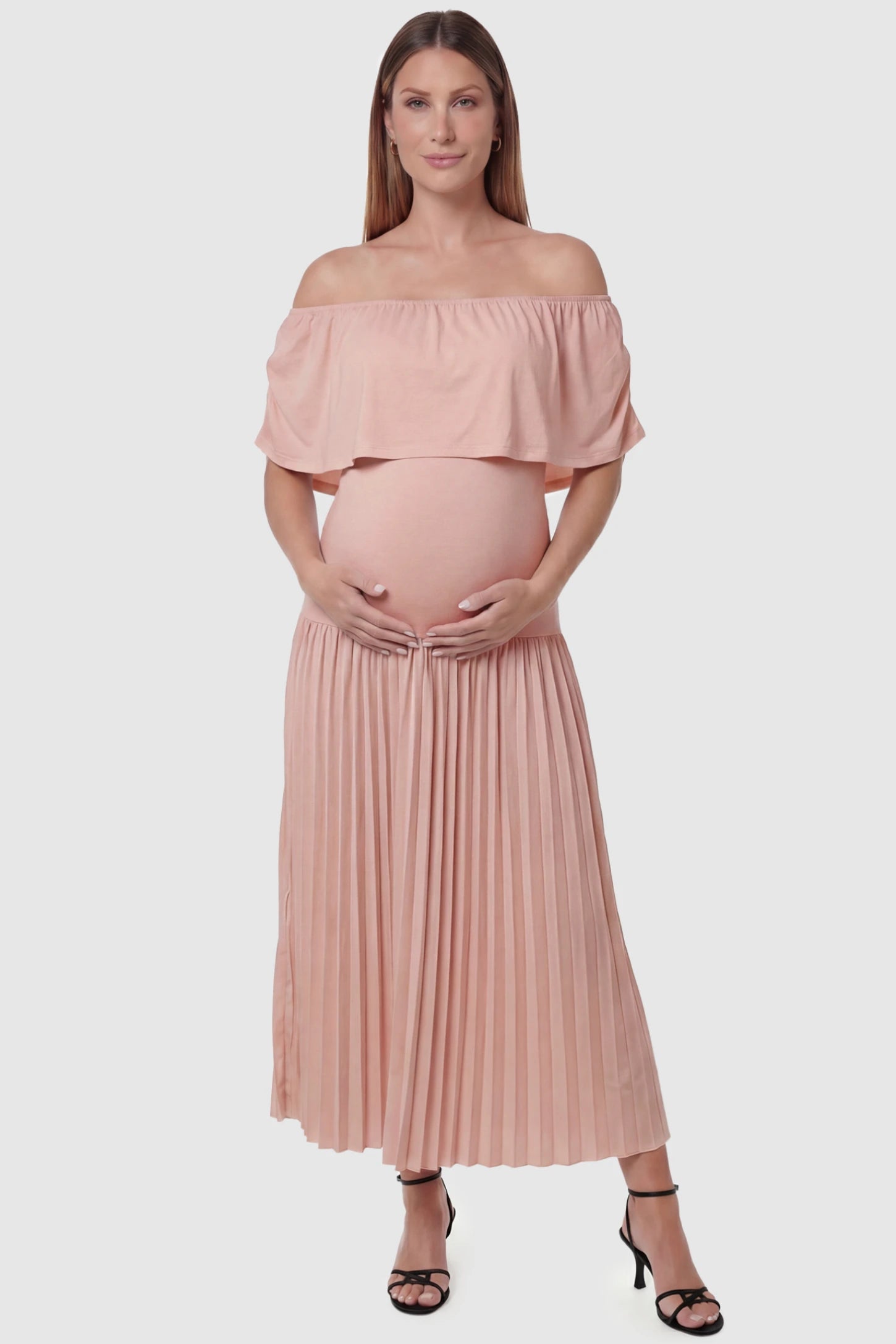 Pleated Off Shoulder Maternity Maxi Dress Pleated Off Shoulder Maternity Maxi Dress  in Pink featuring a high stretch pleated maxi skirt on a pregnant model, front view.