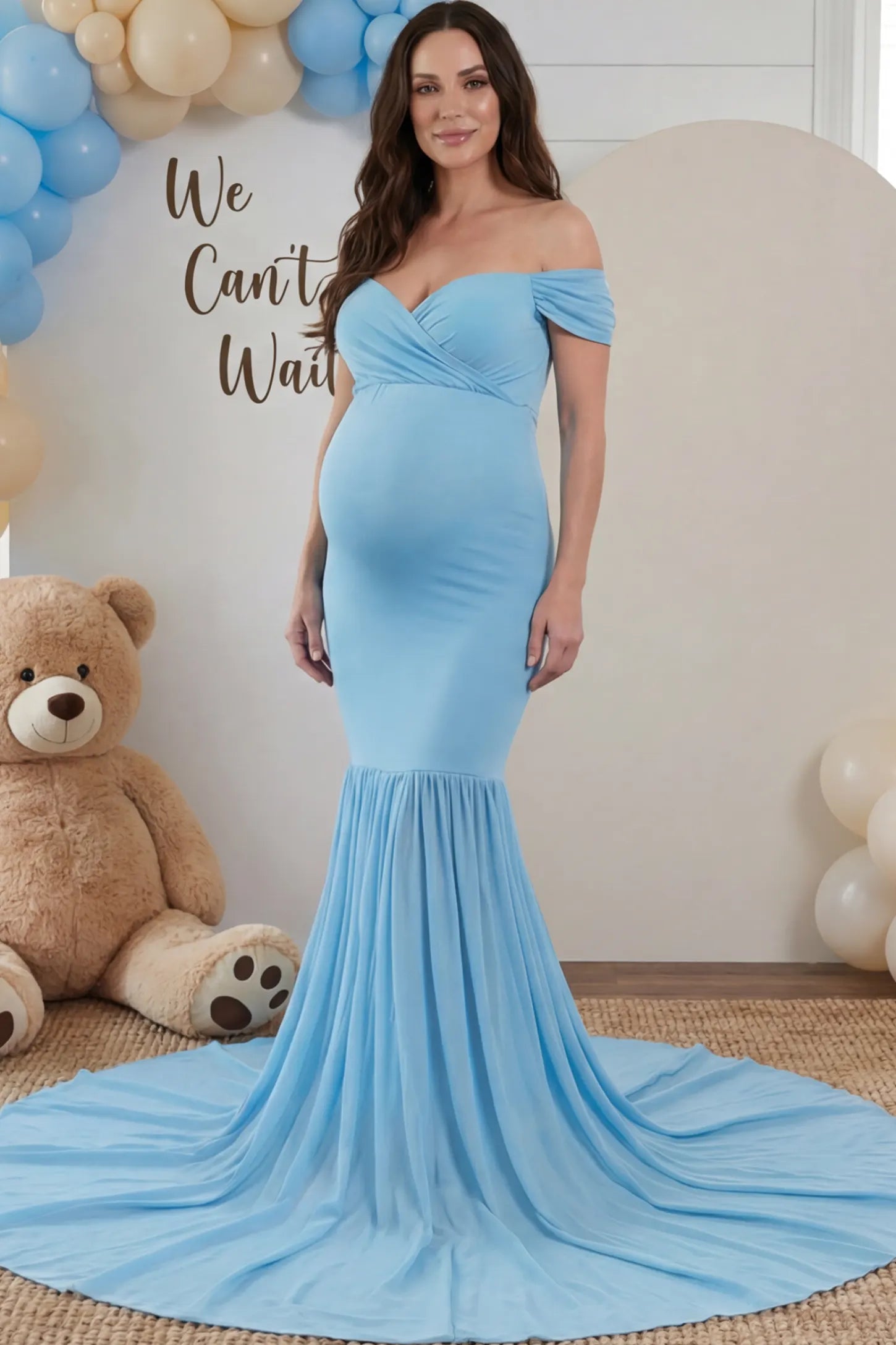 Solid Off Shoulder Mermaid Maternity Photoshoot Gown Solid Off Shoulder Mermaid Maternity Photoshoot Gown in Blue featuring a sweetheart neckline and dramatic pleated train on a pregnant woman.