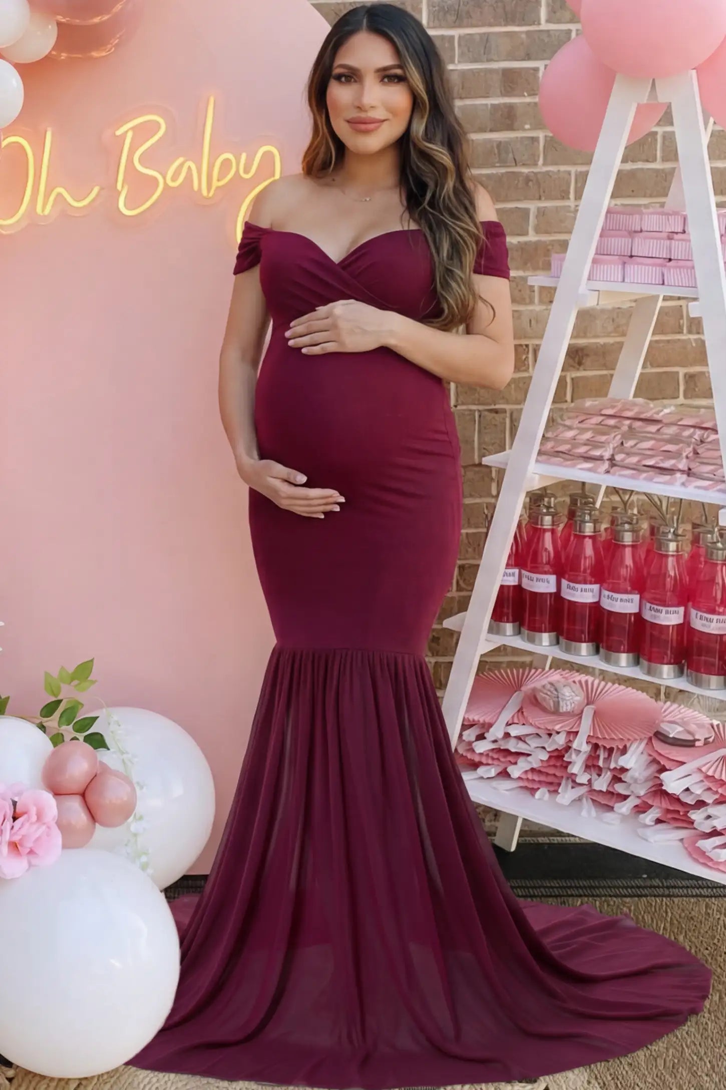 Solid Off Shoulder Mermaid Maternity Photoshoot Gown Solid Off Shoulder Mermaid Maternity Photoshoot Gown in burgundy featuring a sweetheart neckline and dramatic pleated train on a pregnant woman.