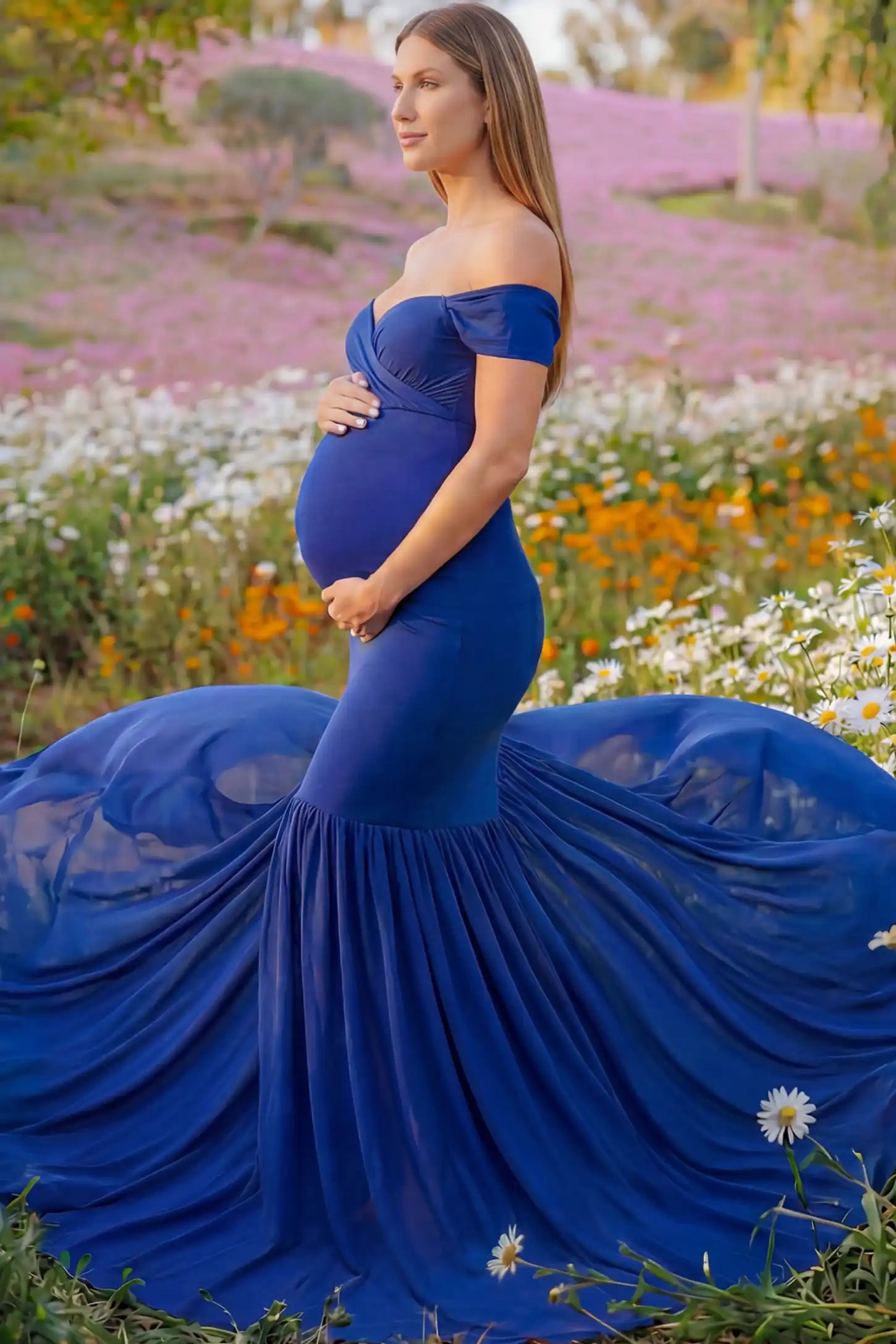 Solid Off Shoulder Mermaid Maternity Photoshoot Gown Solid Off Shoulder Mermaid Maternity Photoshoot Gown in dark blue featuring a sweetheart neckline and dramatic pleated train on a pregnant model showing side.