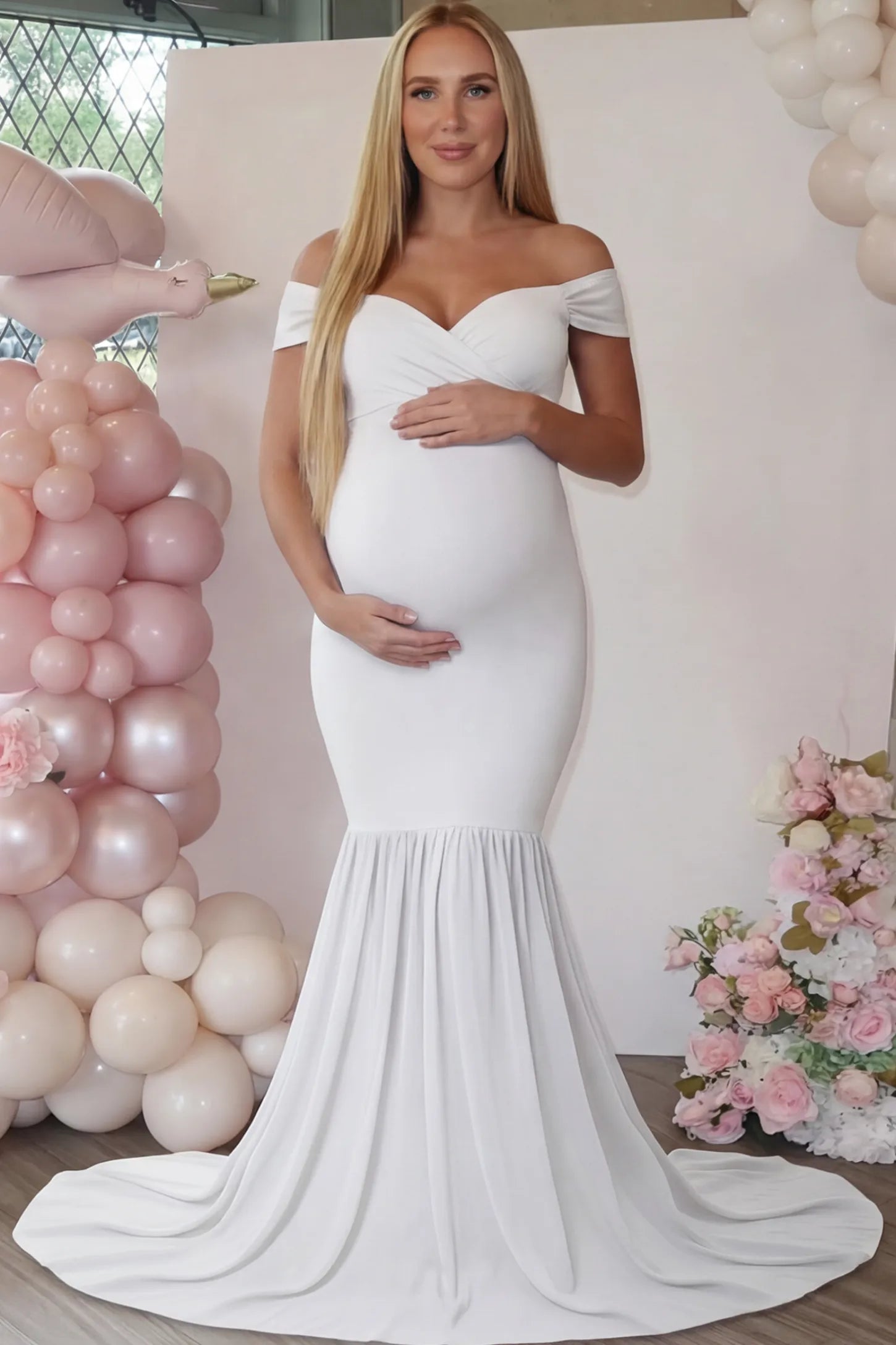 Solid Off Shoulder Mermaid Maternity Photoshoot Gown Solid Off Shoulder Mermaid Maternity Photoshoot Gown in white featuring a sweetheart neckline and dramatic pleated train on a pregnant woman.