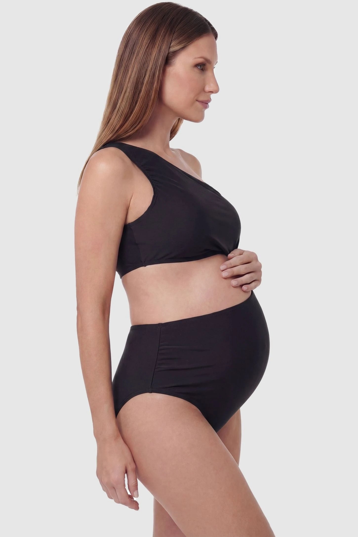 One-Shoulder Cutout Maternity Monokini One-Shoulder Cutout Maternity Monokini in Black featuring side-seam ruching on a pregnant model, side view.