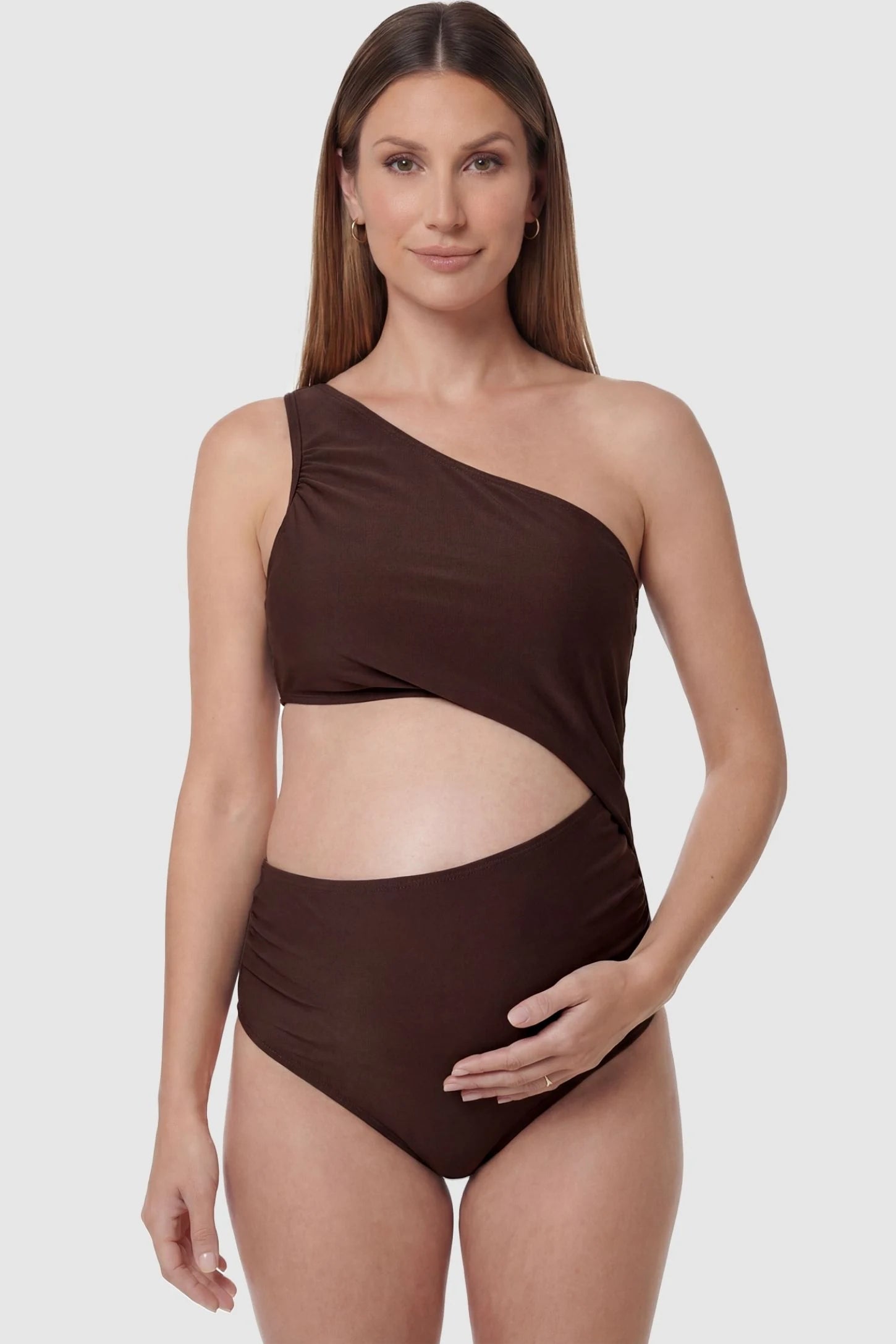 One-Shoulder Cutout Maternity Monokini One-Shoulder Cutout Maternity Monokini in Brown featuring an elegant front cutout on a pregnant model, front view.
