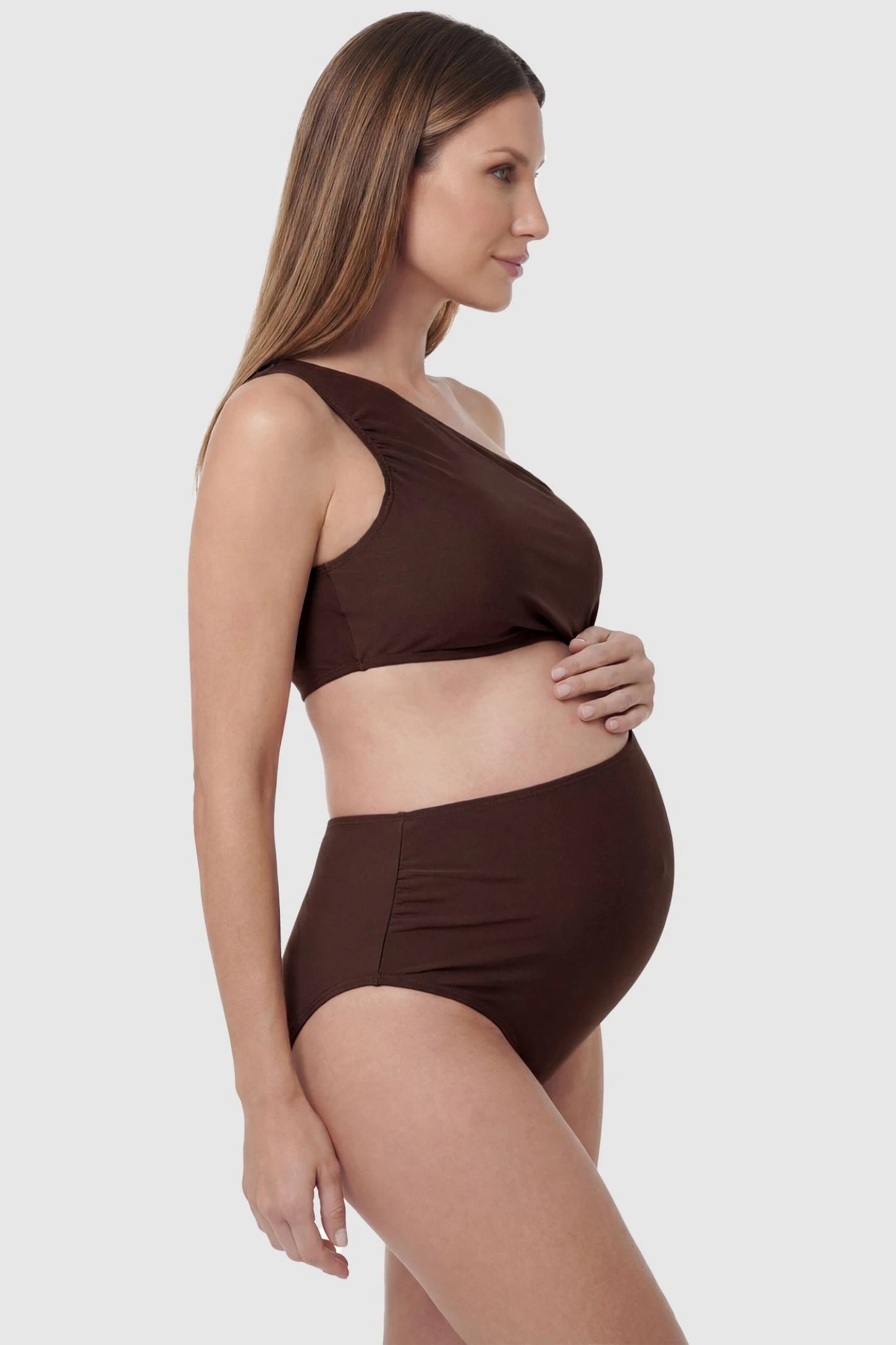 One-Shoulder Cutout Maternity Monokini One-Shoulder Cutout Maternity Monokini in Brown featuring a flexible empire waist on a pregnant model, side view.