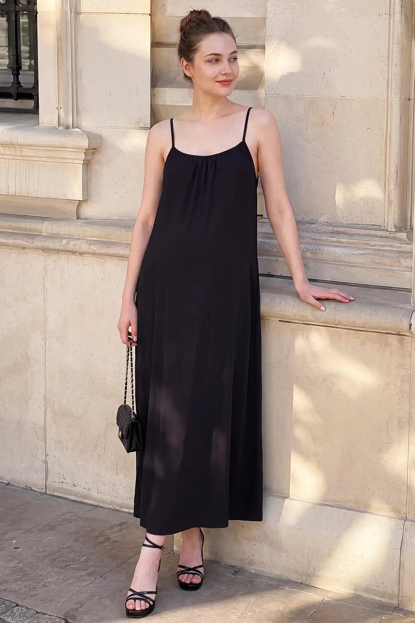 Open Back Flowy Cami Maternity Dress Open Back Flowy Cami Maternity Dress in Black long length with a breezy open back, lifestyle view on a non pregnant model.