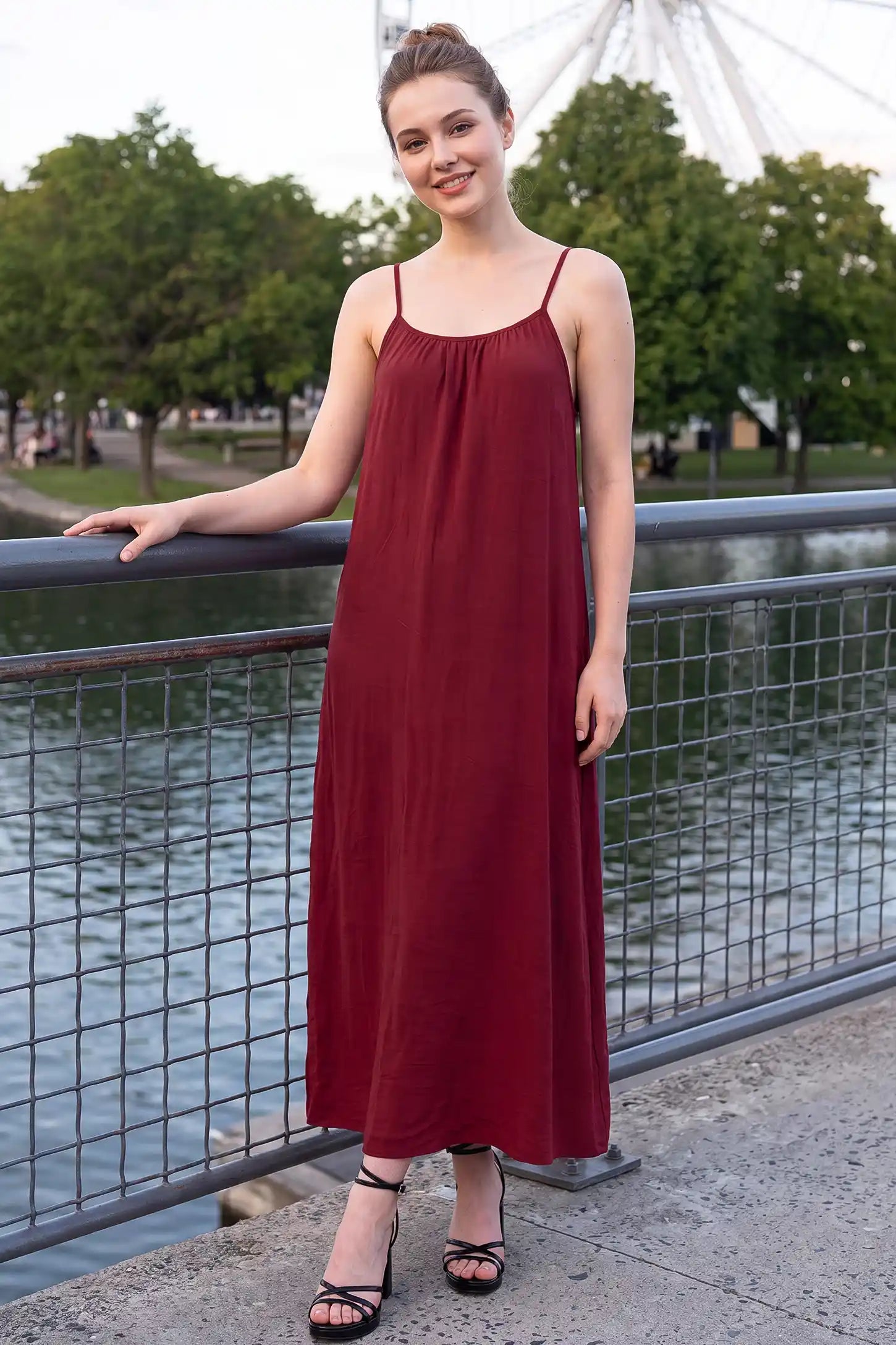 Open Back Flowy Cami Maternity Dress Open Back Flowy Cami Maternity Dress in Date Red long length with a breezy open back, lifestyle view on a non pregnant model.