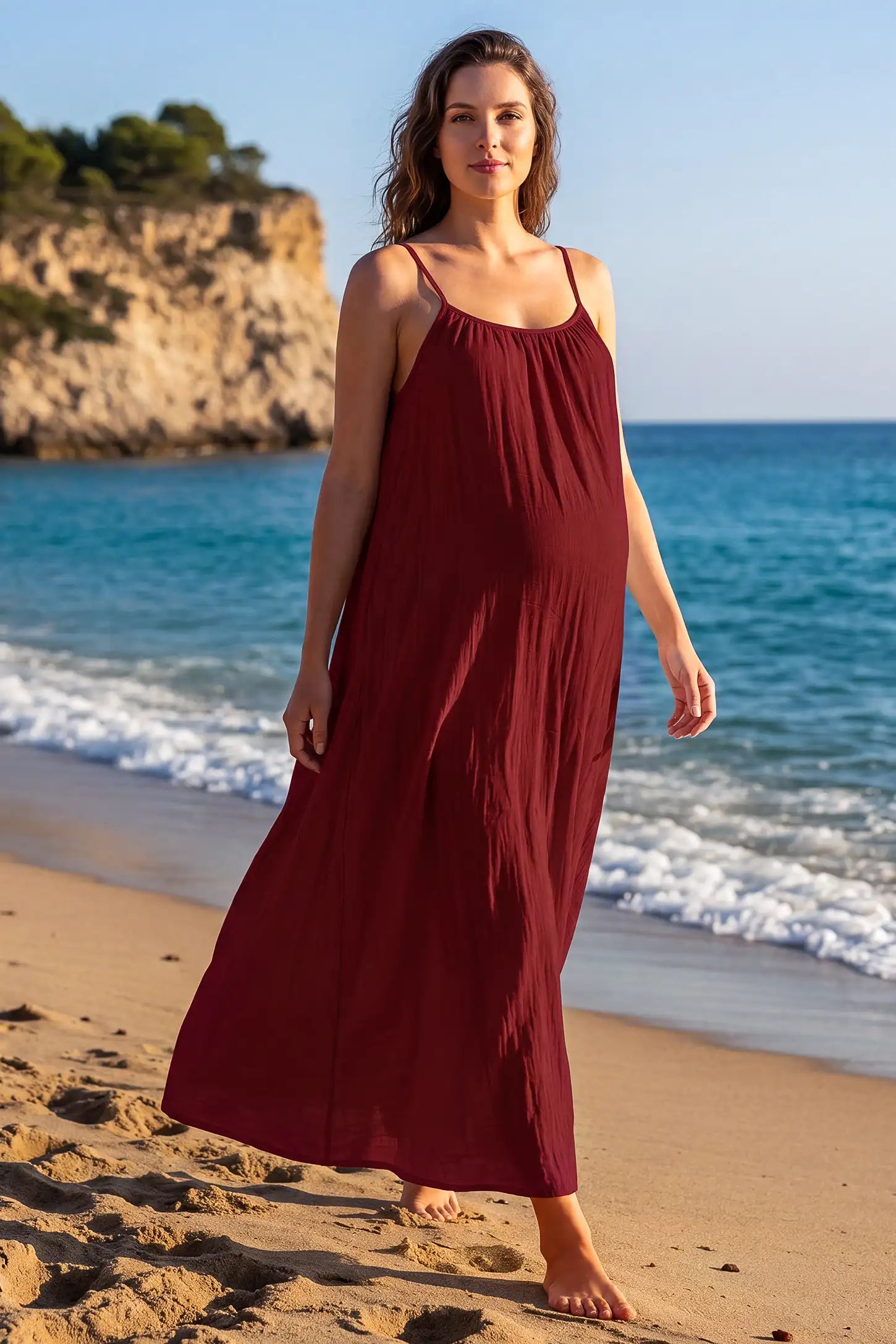 Open Back Flowy Cami Maternity Dress Open Back Flowy Cami Long Maternity Dress in Date Red with an open back design, lifestyle view on a pregnant model.