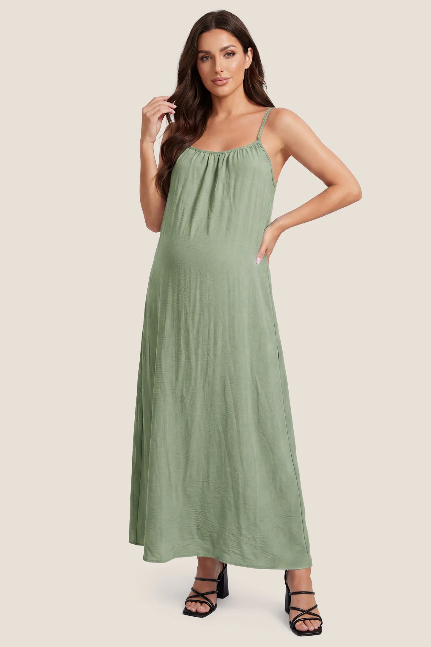 Open Back Flowy Cami Maternity Dress Open Back Flowy Cami Long Maternity Dress in Military Green featuring open back details and flowy cami straps, front view on a pregnant model.