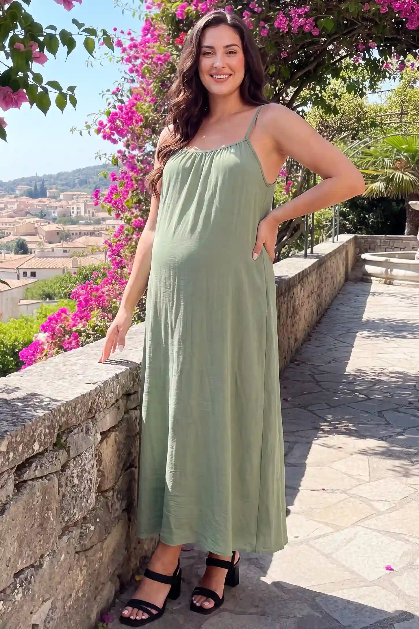 Open Back Flowy Cami Maternity Dress Open Back Flowy Cami Maternity Dress in Military Green long length with a breezy open back, lifestyle view on a plus-size model.