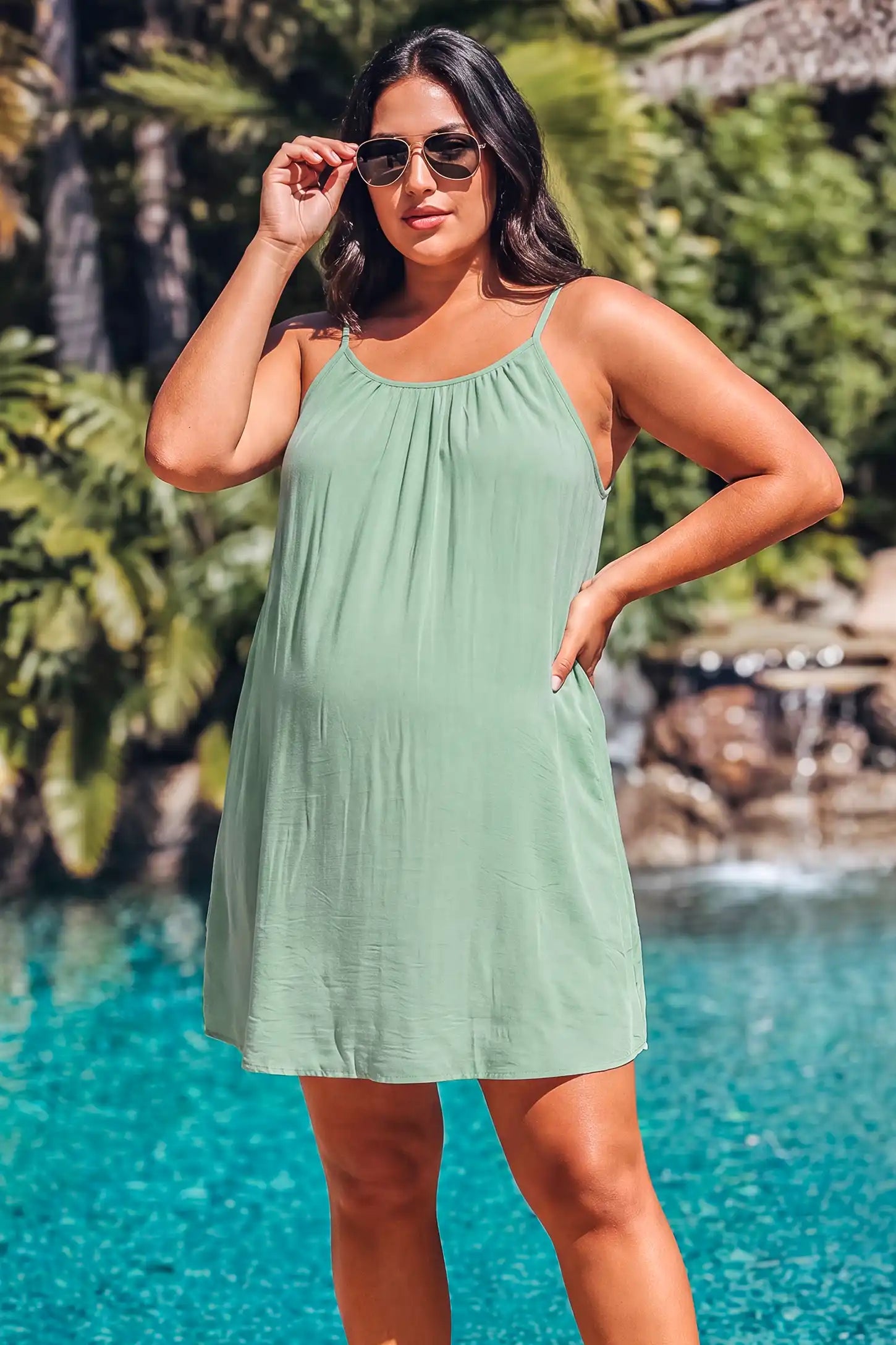 Open Back Flowy Cami Maternity Dress Open Back Flowy Cami Maternity Dress in Military Green short length with a breezy open back, lifestyle view on a plus-size model.
