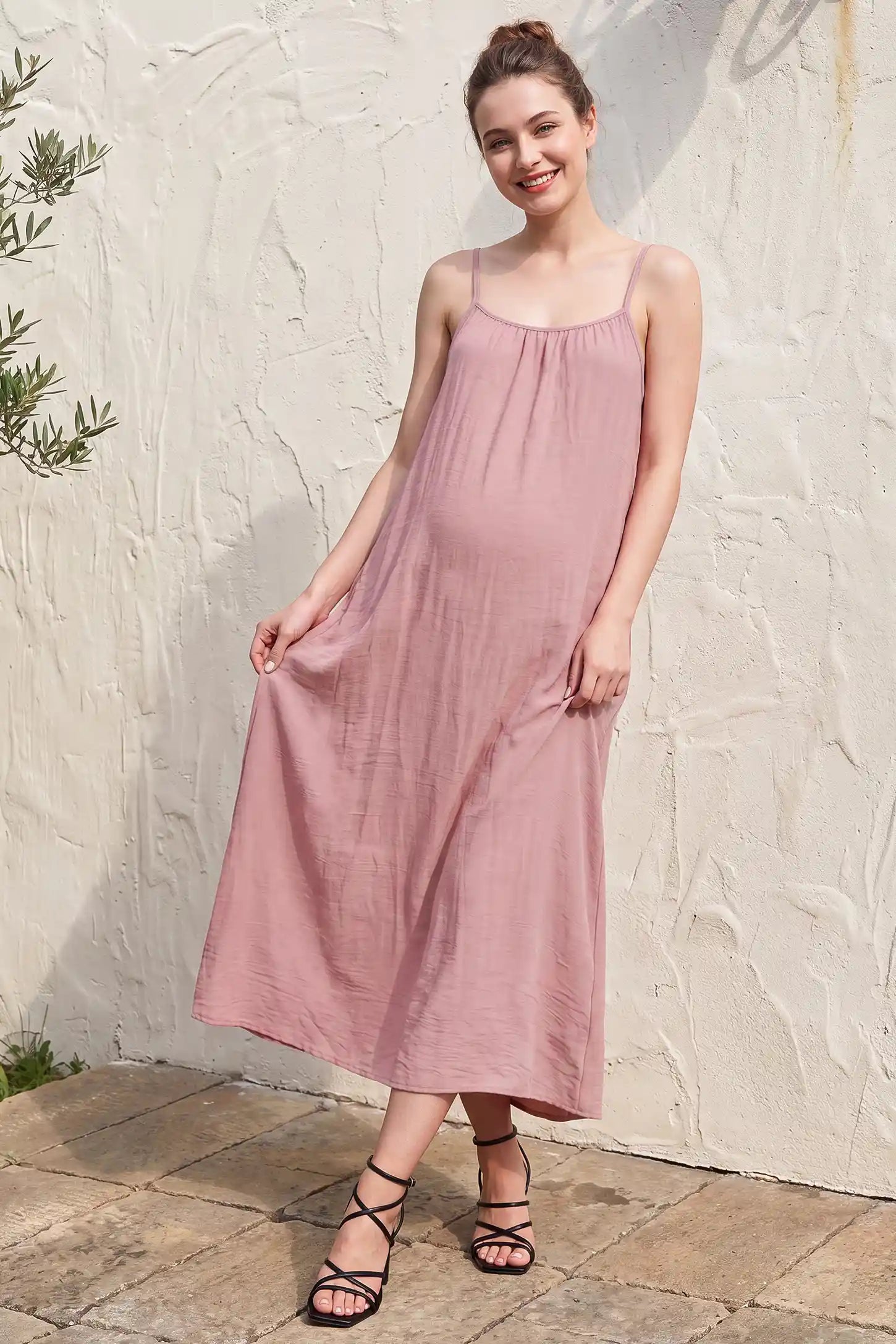 Open Back Flowy Cami Maternity Dress Open Back Flowy Cami Maternity Dress in Pink Striped long length with a breezy open back, lifestyle view on a non pregnant model.