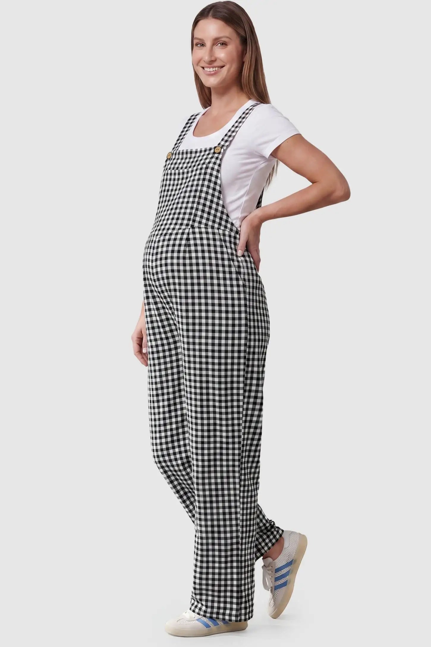 Plaid Square-Neck Button-Detail Maternity Jumpsuit Plaid Square-Neck Button-Detail Maternity Jumpsuit in Black featuring wood-tone buttons on a pregnant model in a side view.
