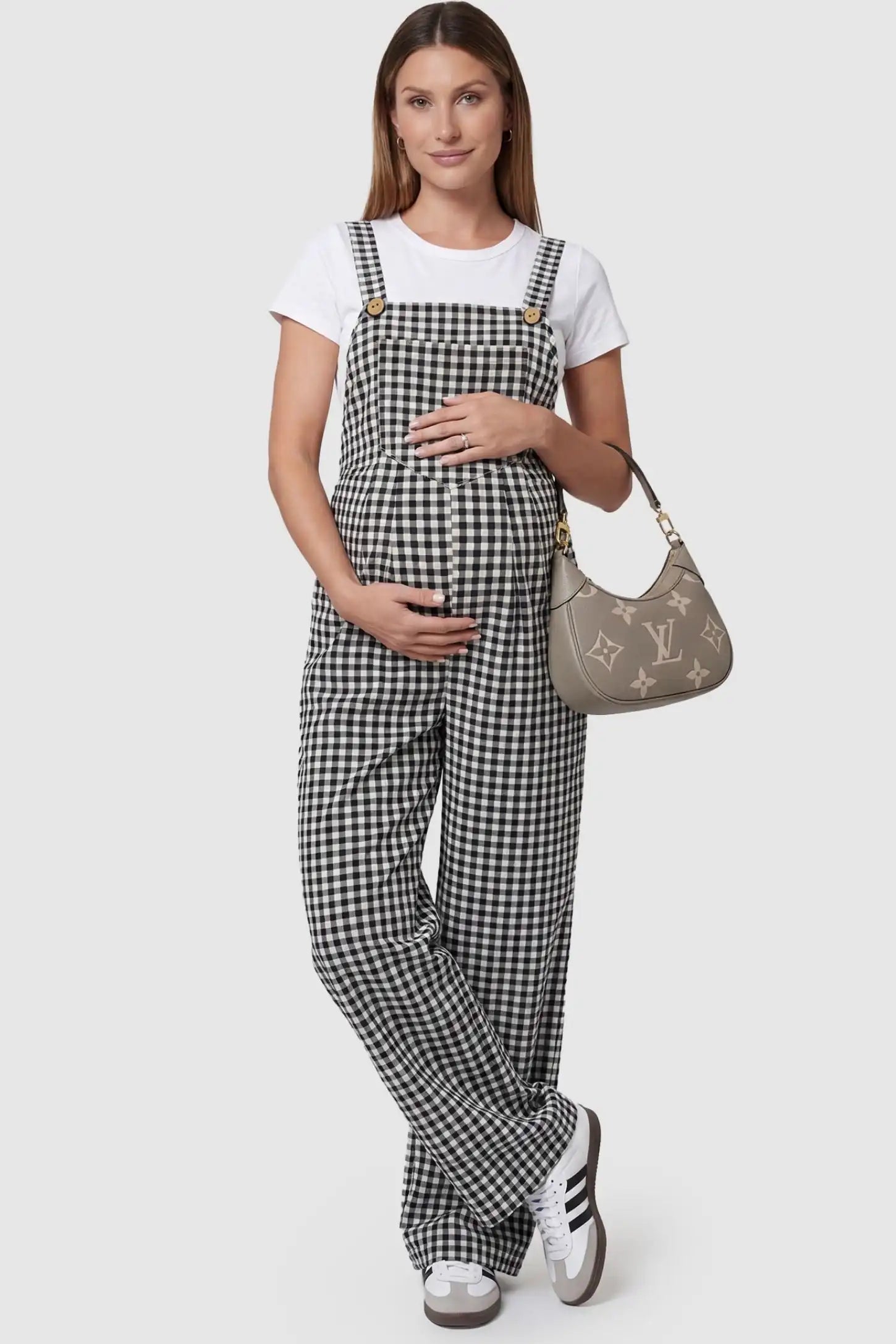 Plaid Square-Neck Button-Detail Maternity Jumpsuit Plaid Square-Neck Button-Detail Maternity Jumpsuit in Black featuring a front pocket on a pregnant model in a front view.