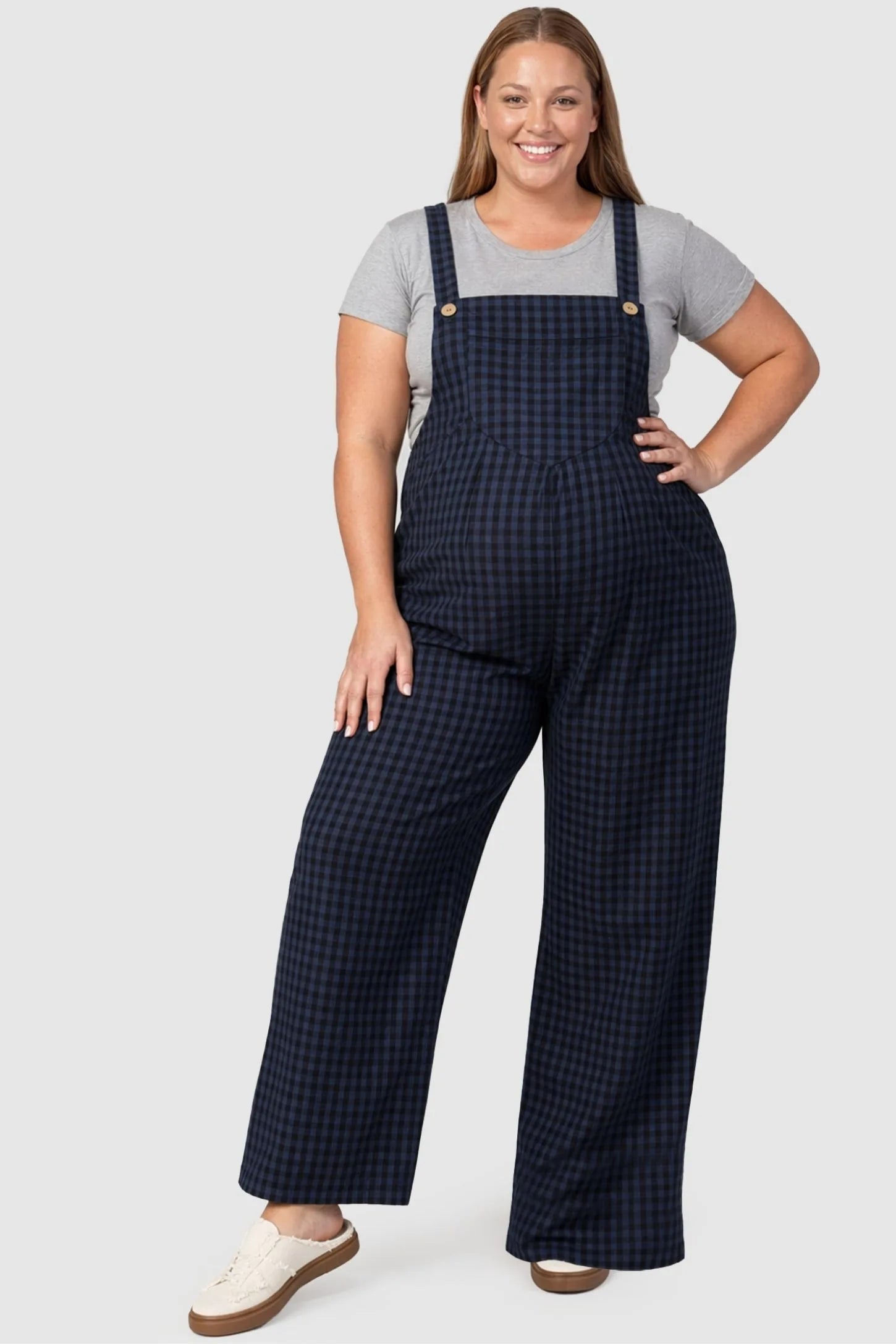 Plaid Square-Neck Button-Detail Maternity Jumpsuit Plaid Square-Neck Button-Detail Maternity Jumpsuit in Blue featuring plaid print on a plus size pregnant model in a front view.