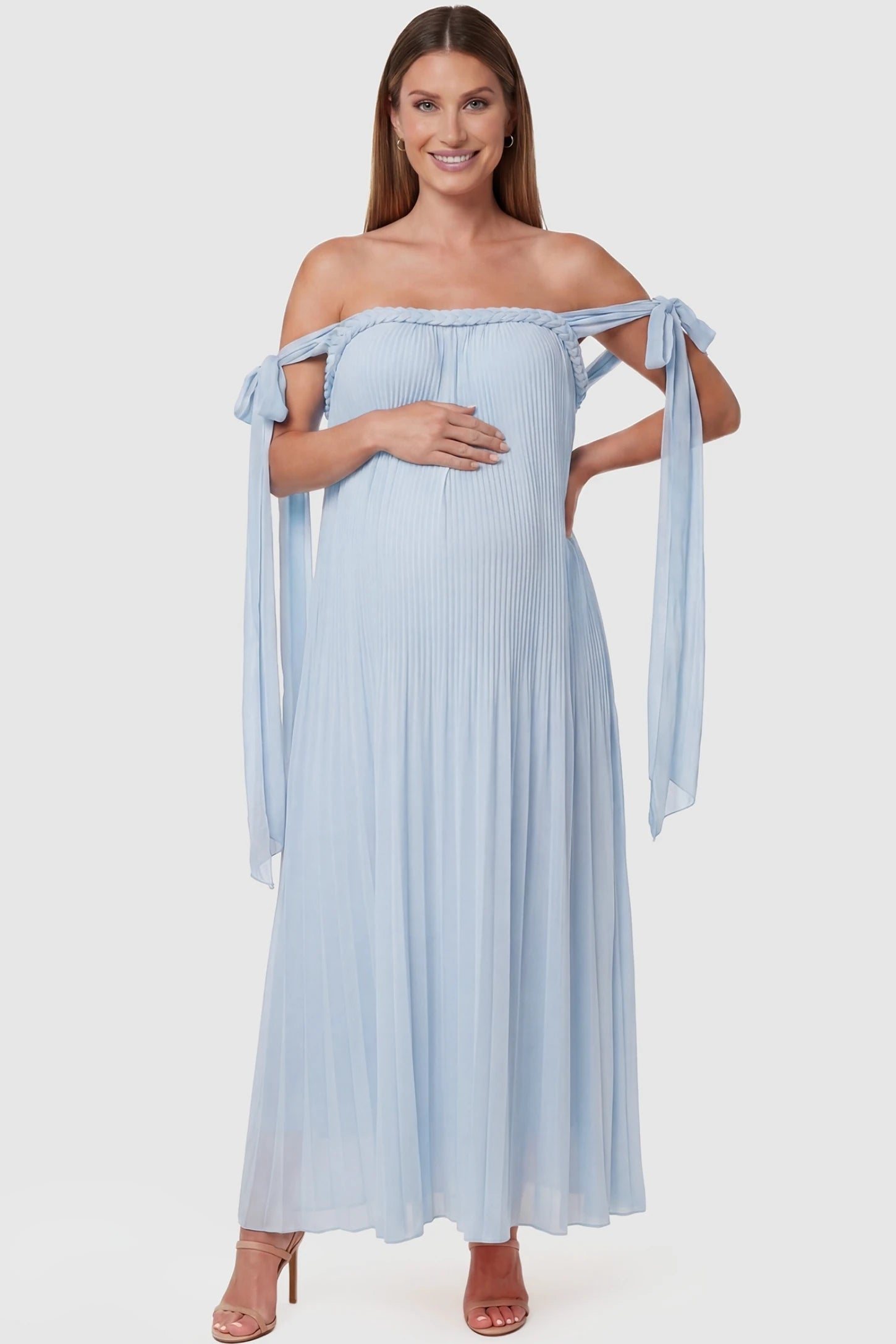 Pleated Braided Cold-Shoulder Maxi Maternity Gown Pleated Braided Cold-Shoulder Maxi Maternity Gown in Blue featuring tie sleeves and a braided neckline on a pregnant model, front view.