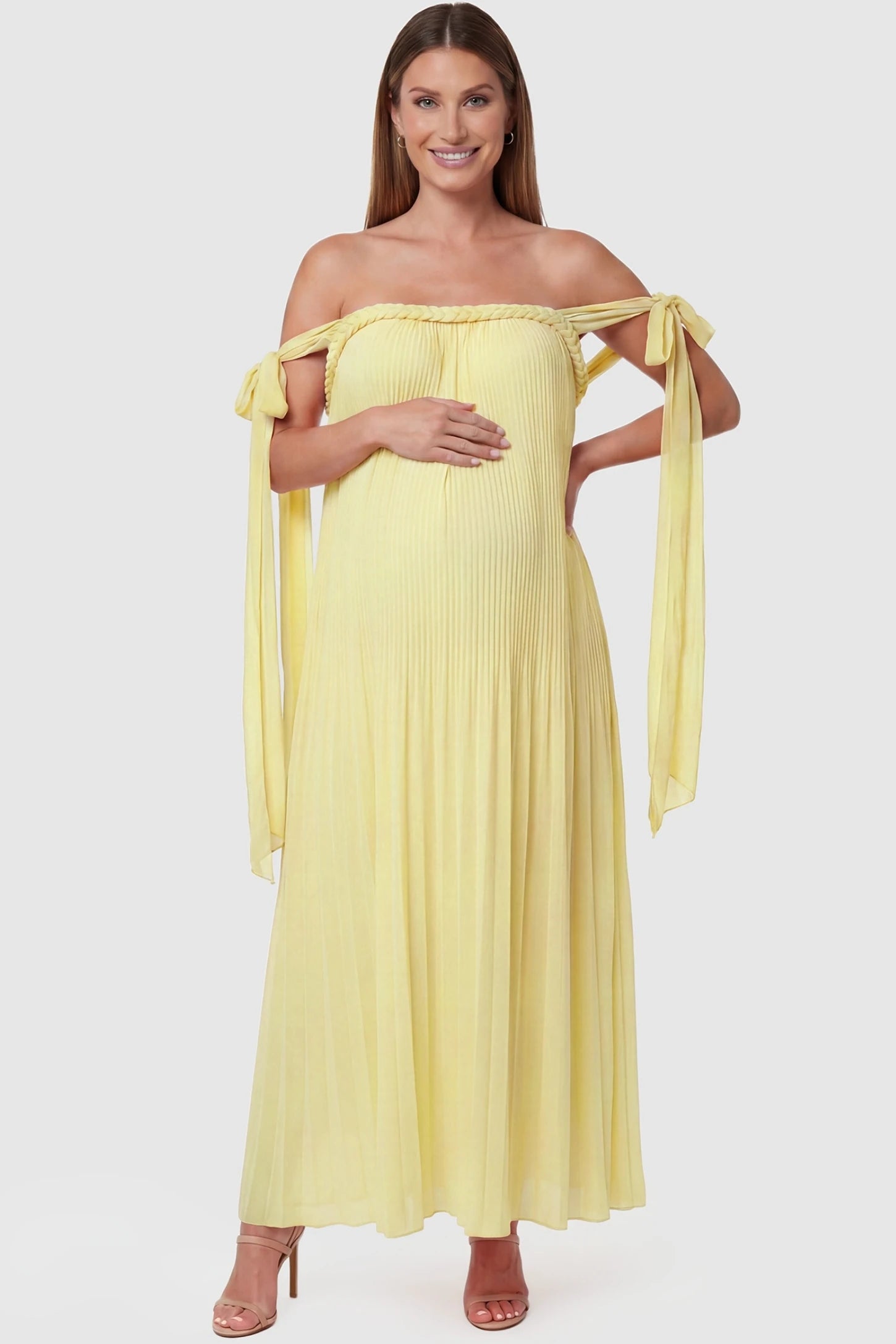 Pleated Braided Cold-Shoulder Maxi Maternity Gown Pleated Braided Cold-Shoulder Maxi Maternity Gown in Yellow featuring tie sleeves and a braided neckline on a pregnant model, front view.