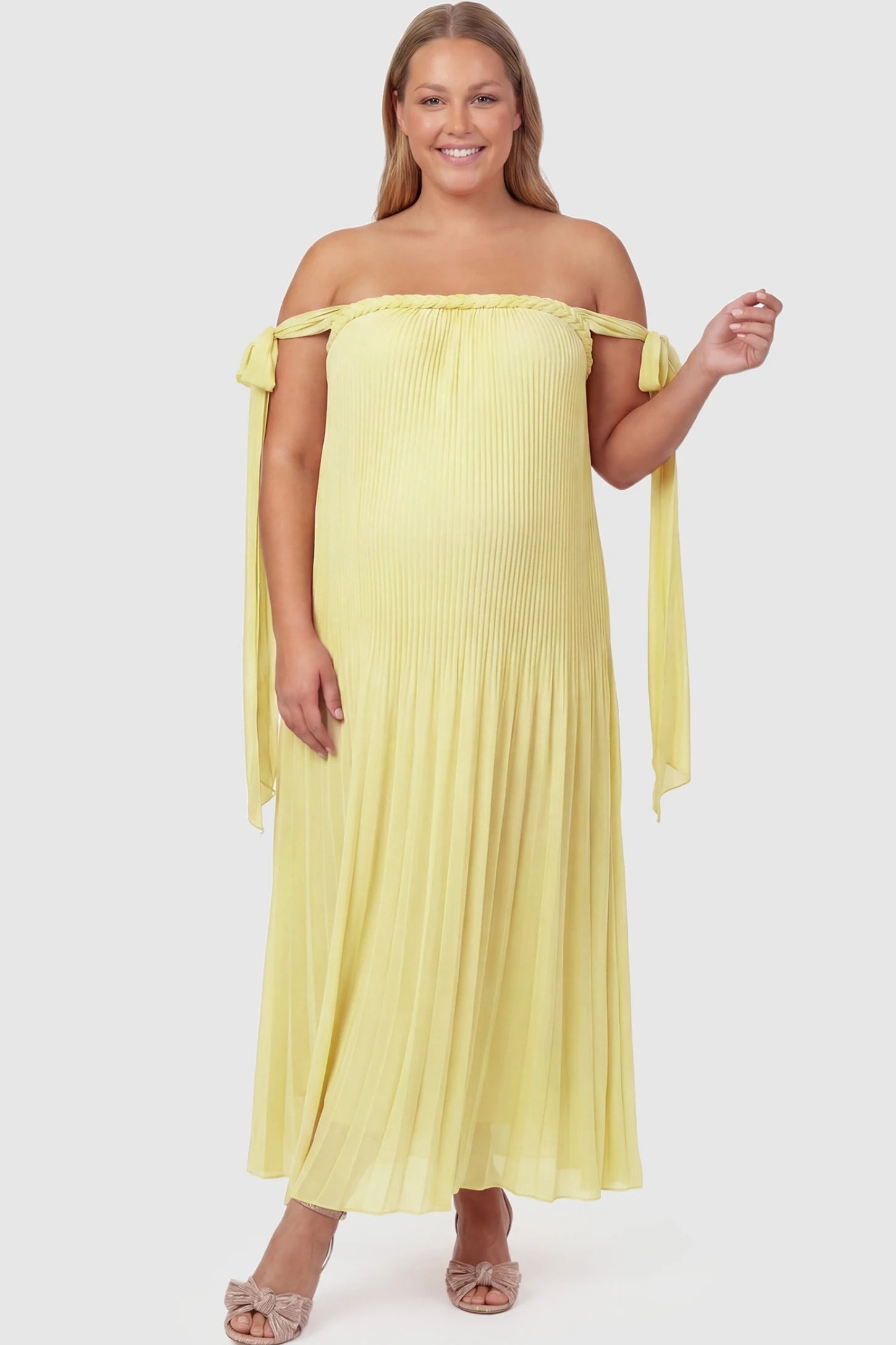 Pleated Braided Cold-Shoulder Maxi Maternity Gown Pleated Braided Cold-Shoulder Maxi Maternity Gown in Yellow featuring a braided neckline on a plus-size pregnant model, front view.