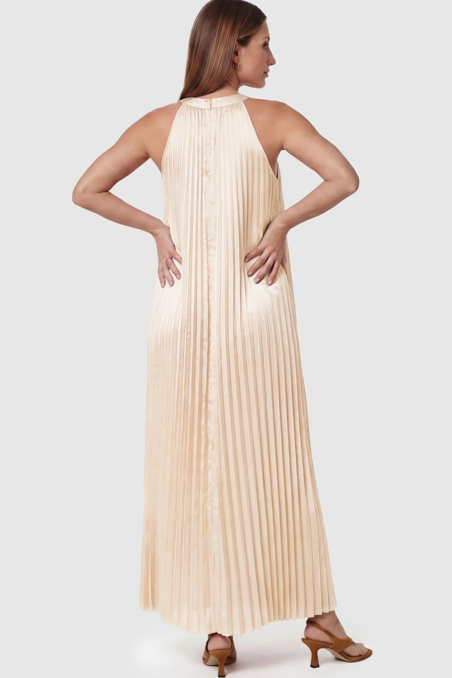 Pleated Faux Silk Halter Maternity Maxi Dress Pleated Faux Silk Halter Maternity Maxi Dress in Champagne featuring micro-pleat texture on a pregnant model showing back view.