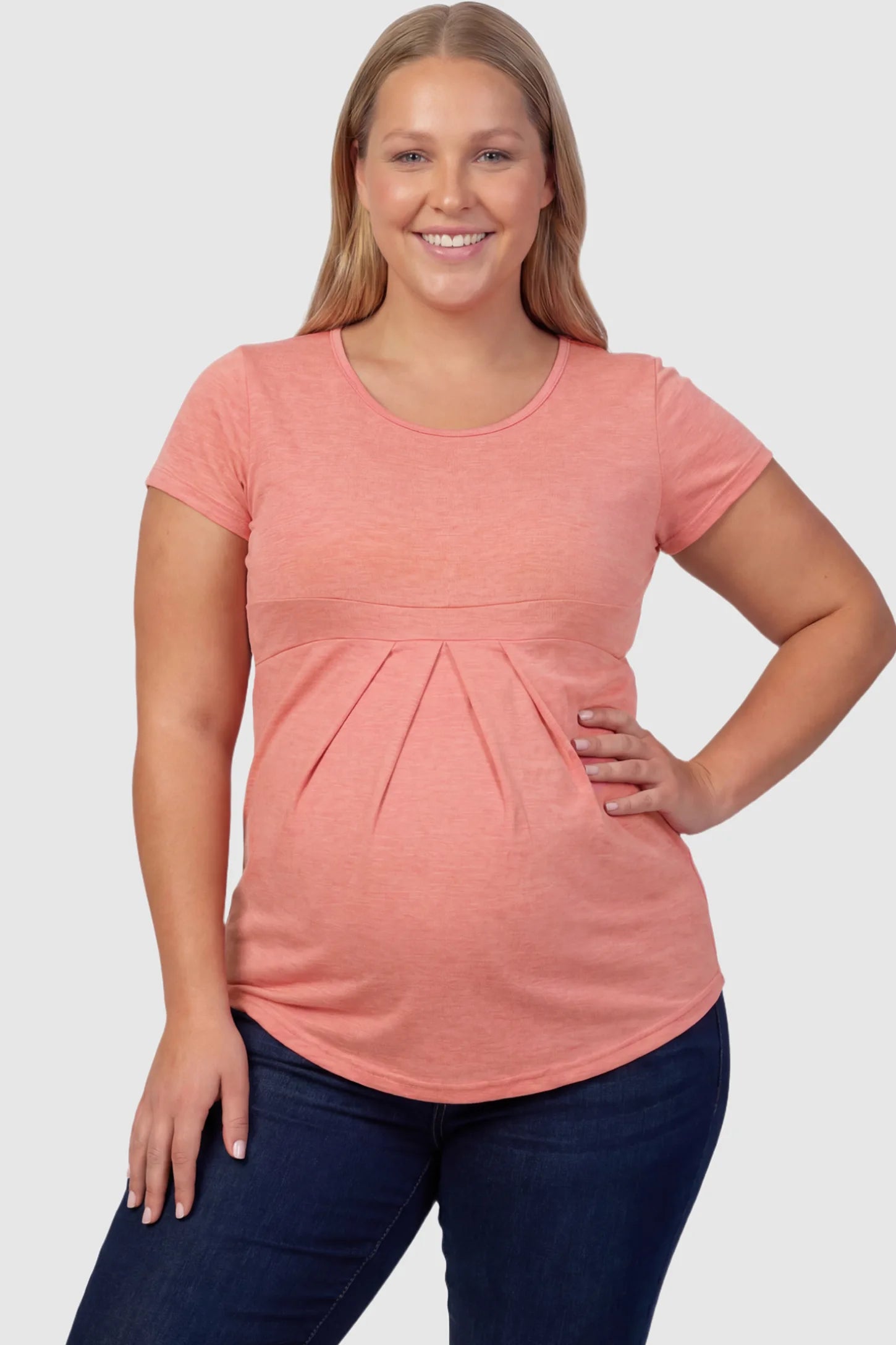 Pleated Heathered Short Sleeve Maternity Top Pleated Heathered Short Sleeve Maternity Top in pink featuring high stretch and breathable fabric on a plus size pregnant model .
