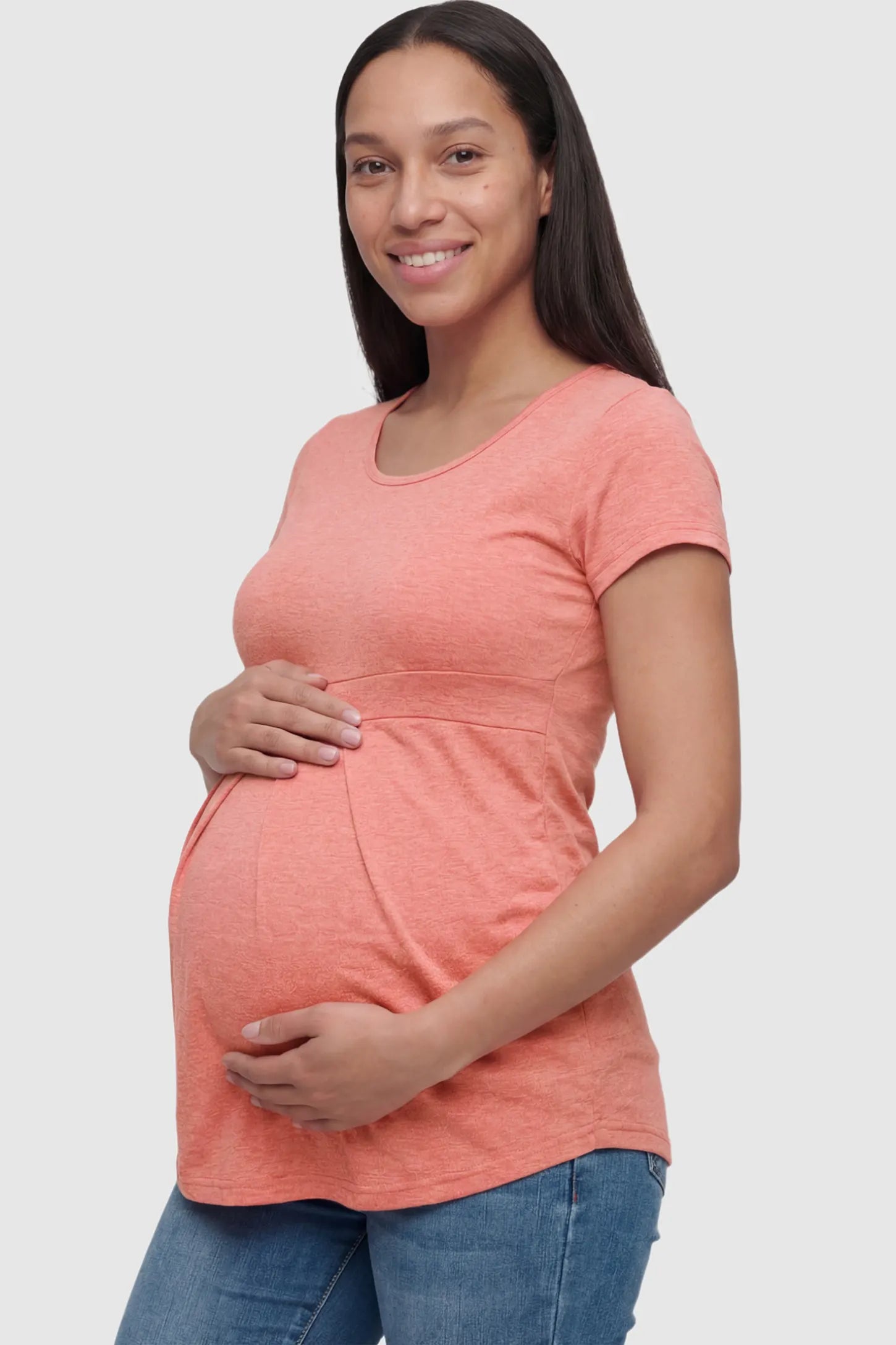 Pleated Heathered Short Sleeve Maternity Top Pleated Heathered Short Sleeve Maternity Top in pink featuring high stretch and breathable fabric on a pregnant model showing side.