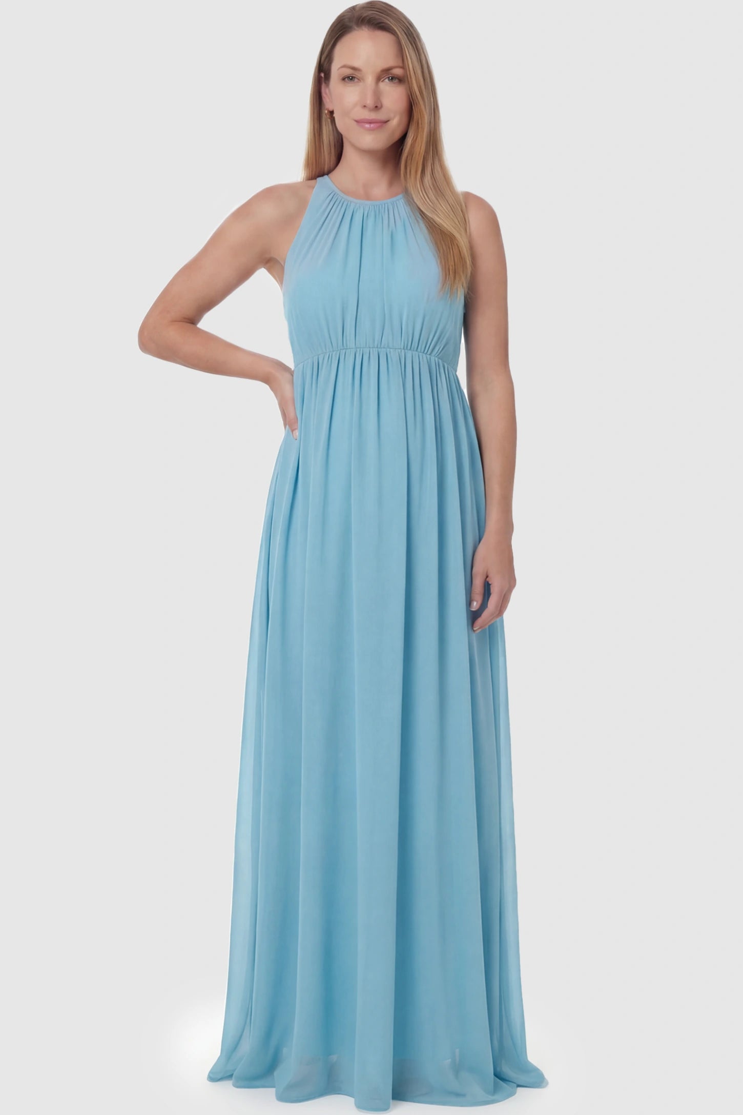 Pleated Mesh Sleeveless Maternity Photoshoot Dress Pleated Mesh Sleeveless Maternity Maxi Dress in light blue featuring an empire waist on a postpartum model.