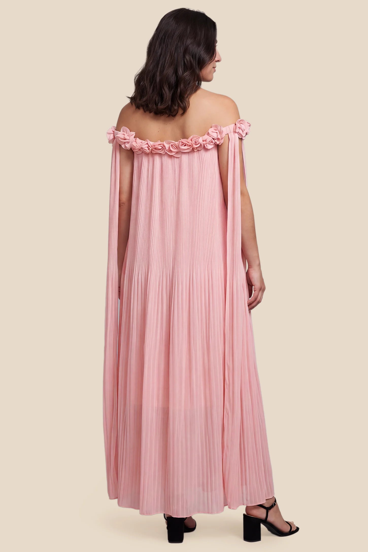Pleated Off-Shoulder Maternity Gown with Rosettes Pleated Off-Shoulder Maternity Gown with Rosettes in Pink showcasing elegant back pleated design, back view on a pregnant model.