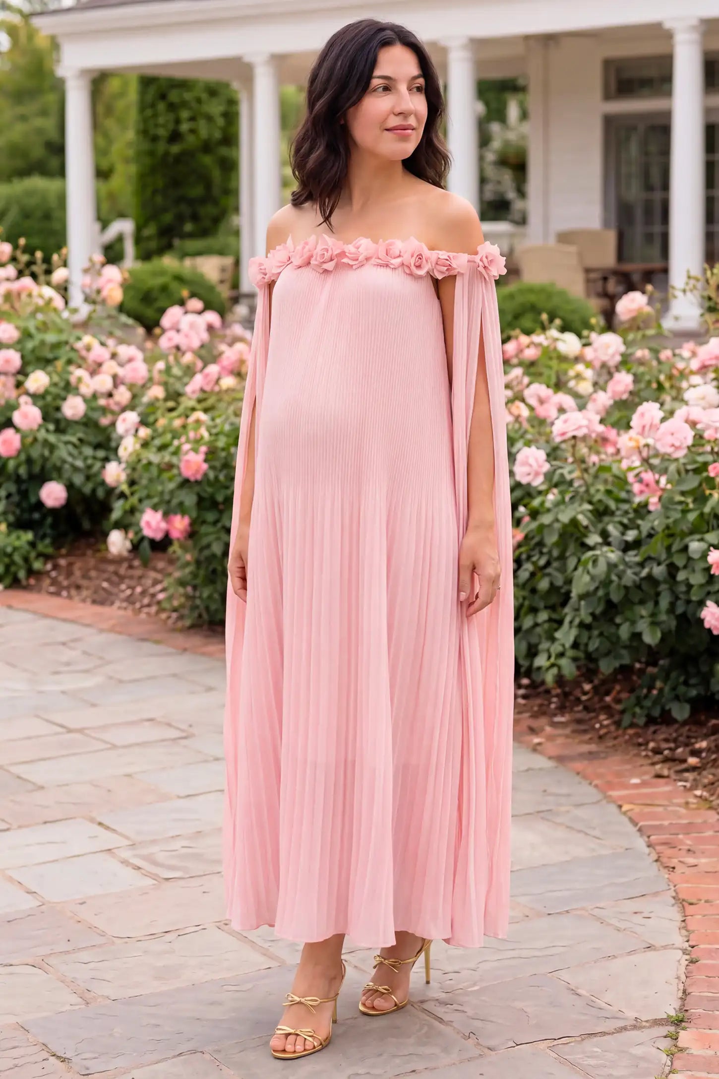 Pleated Off-Shoulder Maternity Gown with Rosettes Pleated Off-Shoulder Maternity Gown with Rosettes in Pink with romantic rosette details, lifestyle view on a plus-size model.