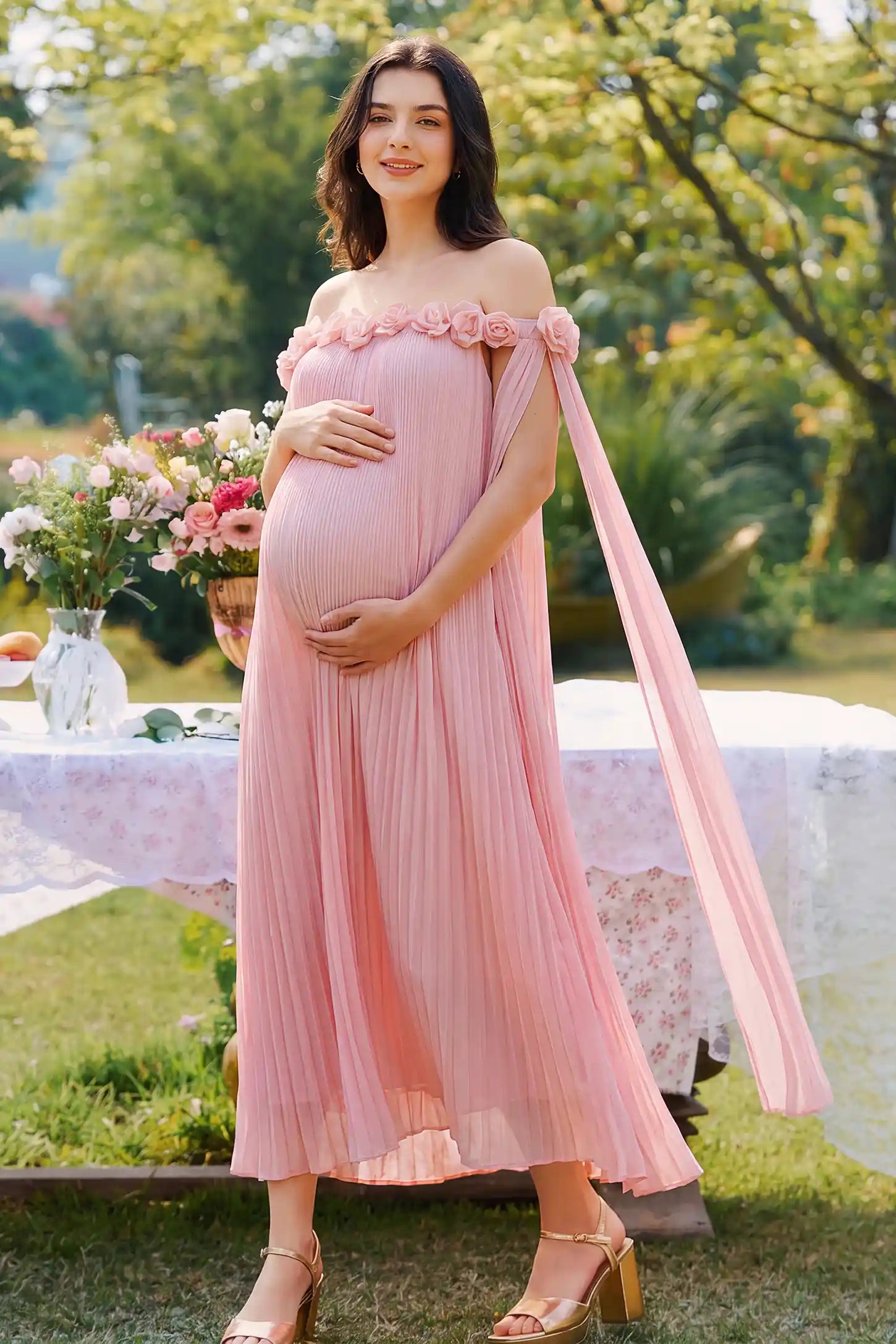 Pleated Off-Shoulder Maternity Gown with Rosettes Pleated Off-Shoulder Maternity Gown with Rosettes in Pink with pleated details, lifestyle view on a pregnant model.