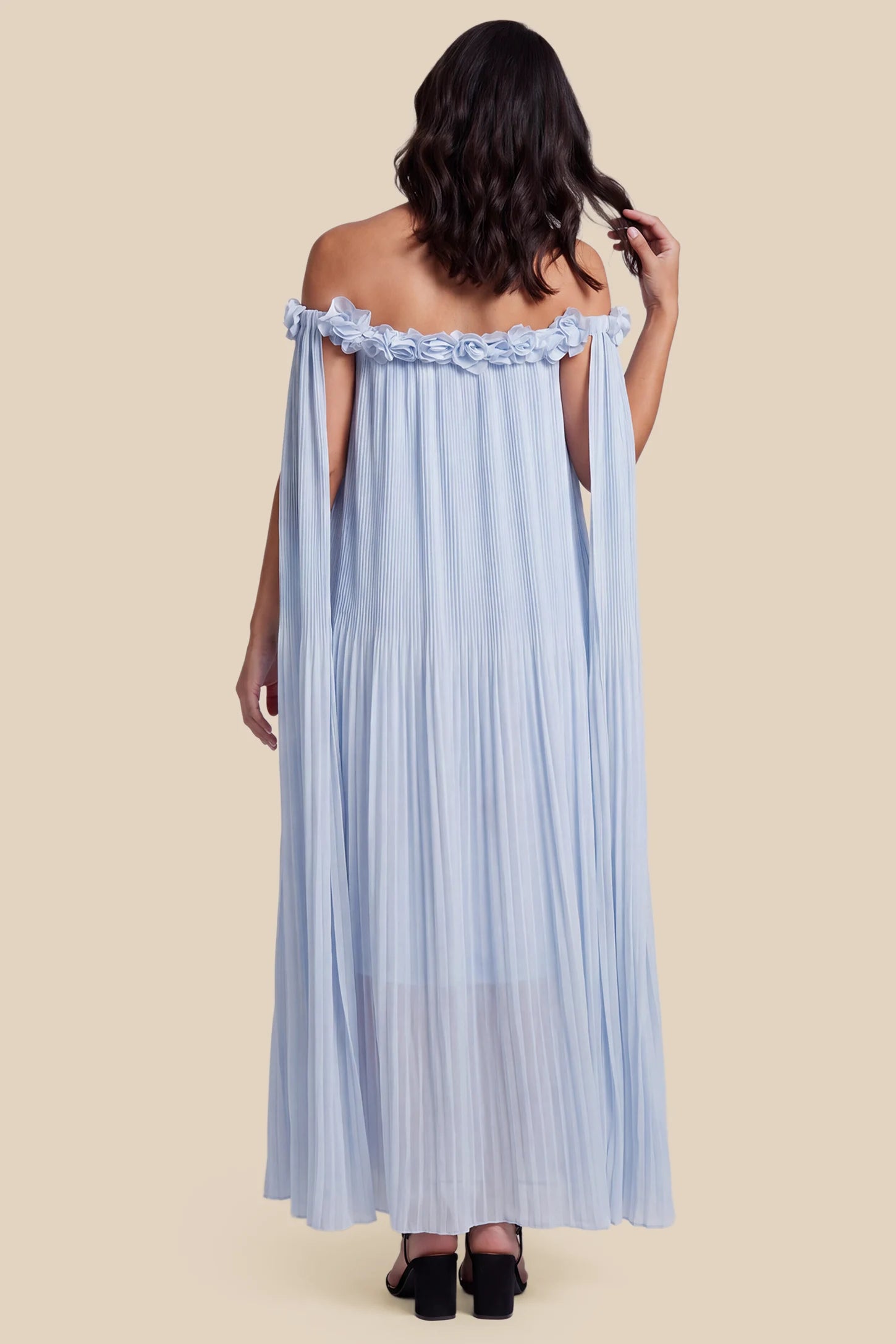 Pleated Off-Shoulder Maternity Gown with Rosettes Pleated Off-Shoulder Maternity Gown with Rosettes in Skye Blue with fluid pleats, side view on a pregnant model.