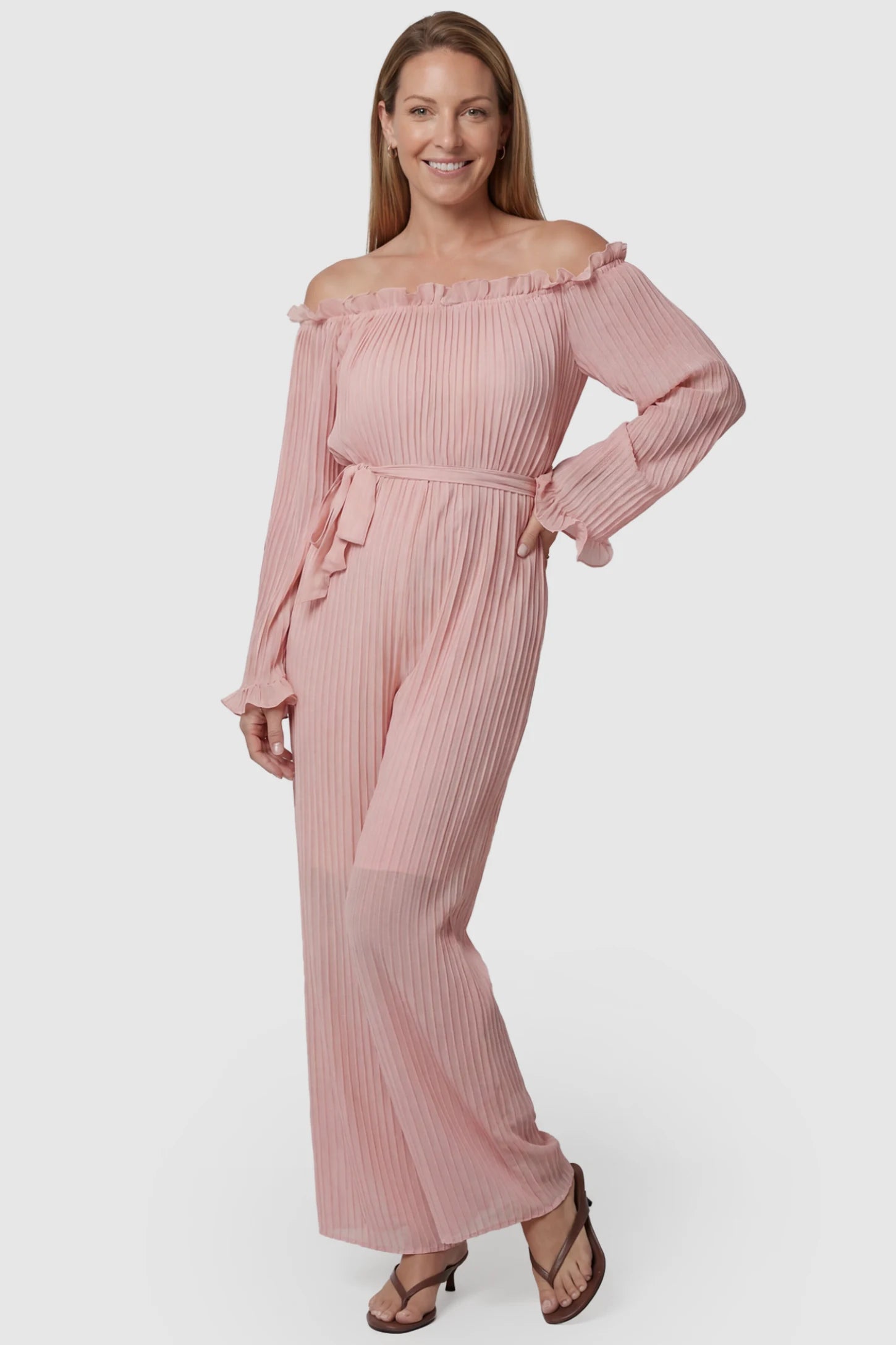 Pleated Off Shoulder Tie-Waist Maternity Jumpsuit Pleated Off Shoulder Tie-Waist Maternity Jumpsuit in Pink featuring a wide-leg silhouette on a postpartum model, front view.
