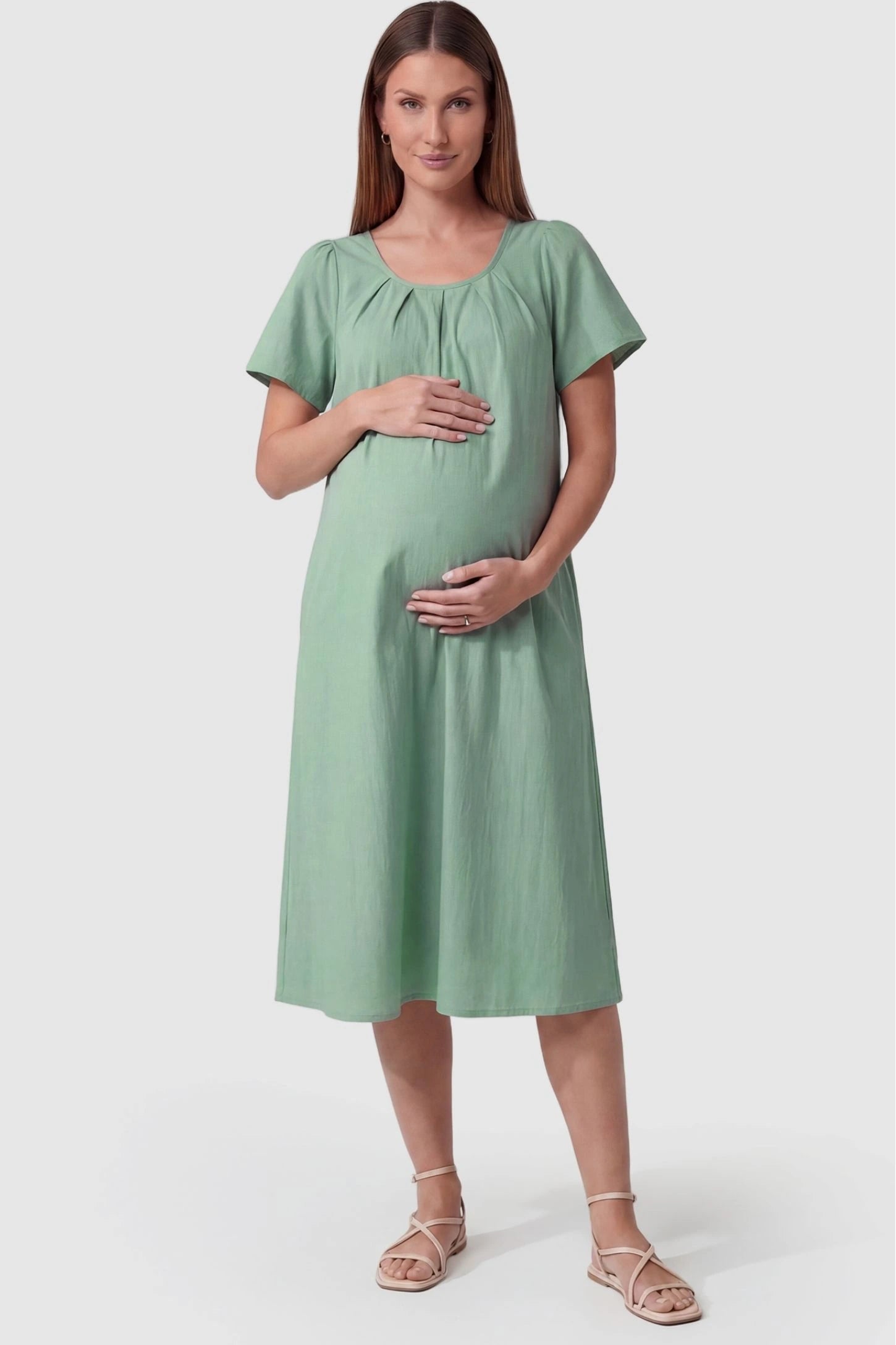 Pleated Round Neck Flowy Midi Maternity Dress Pleated Round Neck Flowy Midi Maternity Dress in Lake Blue featuring a pleated neckline on a pregnant model, front view.