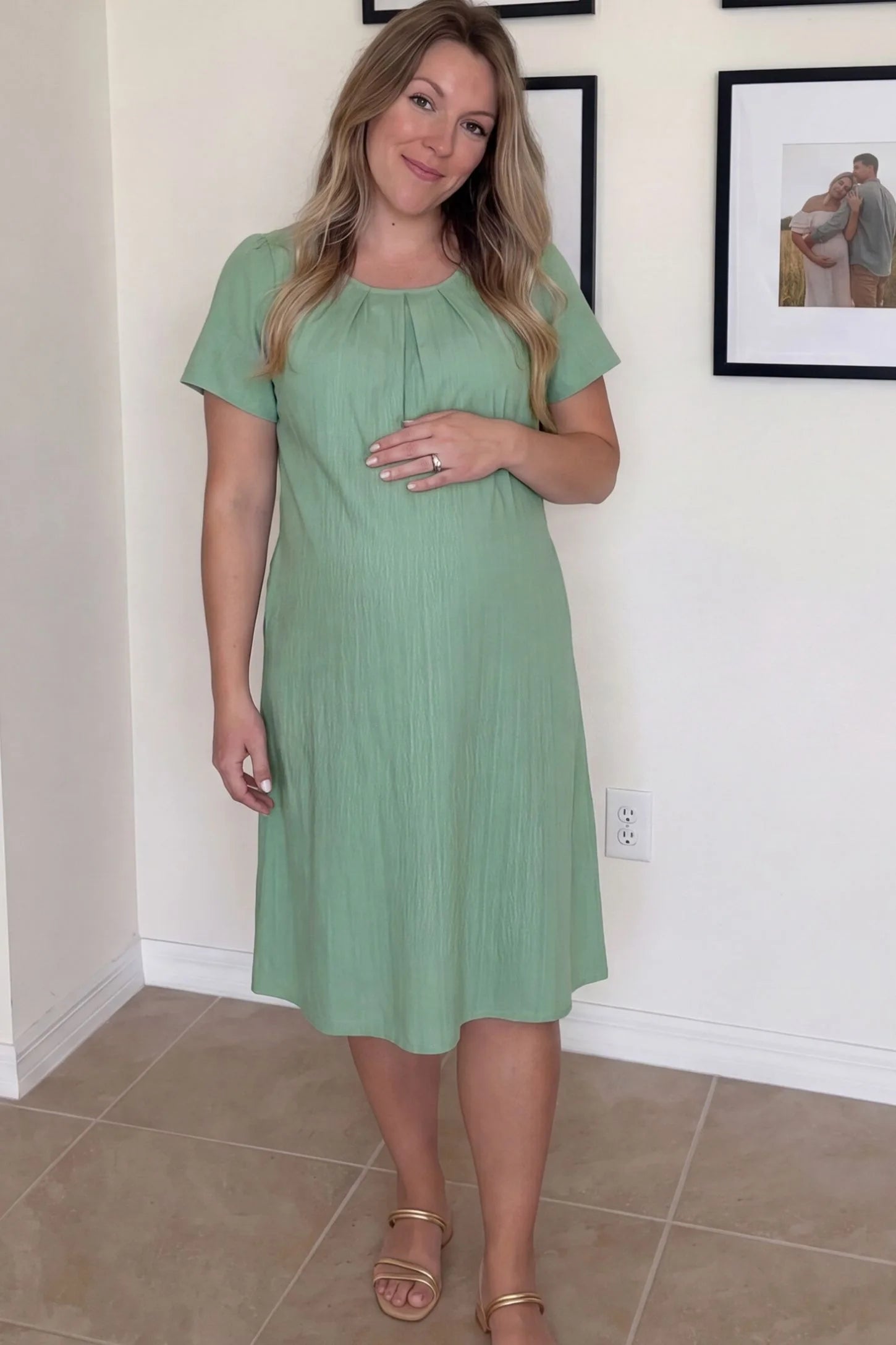 Pleated Round Neck Flowy Midi Maternity Dress Pleated Round Neck Flowy Midi Maternity Dress in Lake Blue featuring comfortable short sleeves on a pregnant model, lifestyle view.