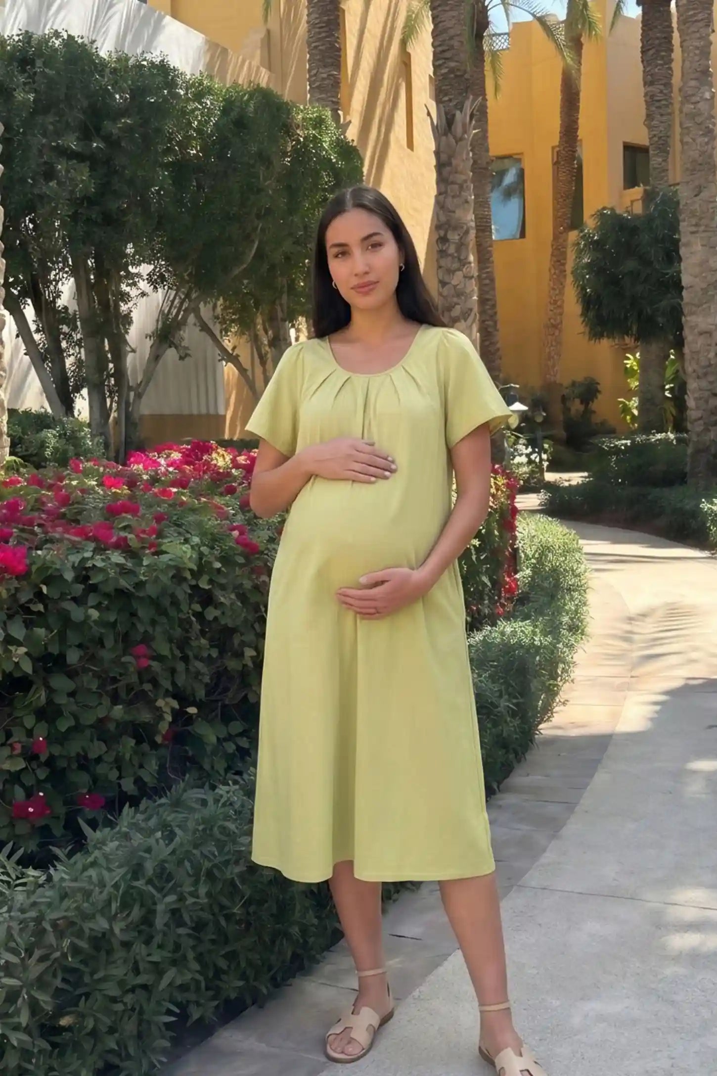 Pleated Round Neck Flowy Midi Maternity Dress Pleated Round Neck Flowy Midi Maternity Dress in Light Green featuring a pleated neckline on a pregnant model, front view.