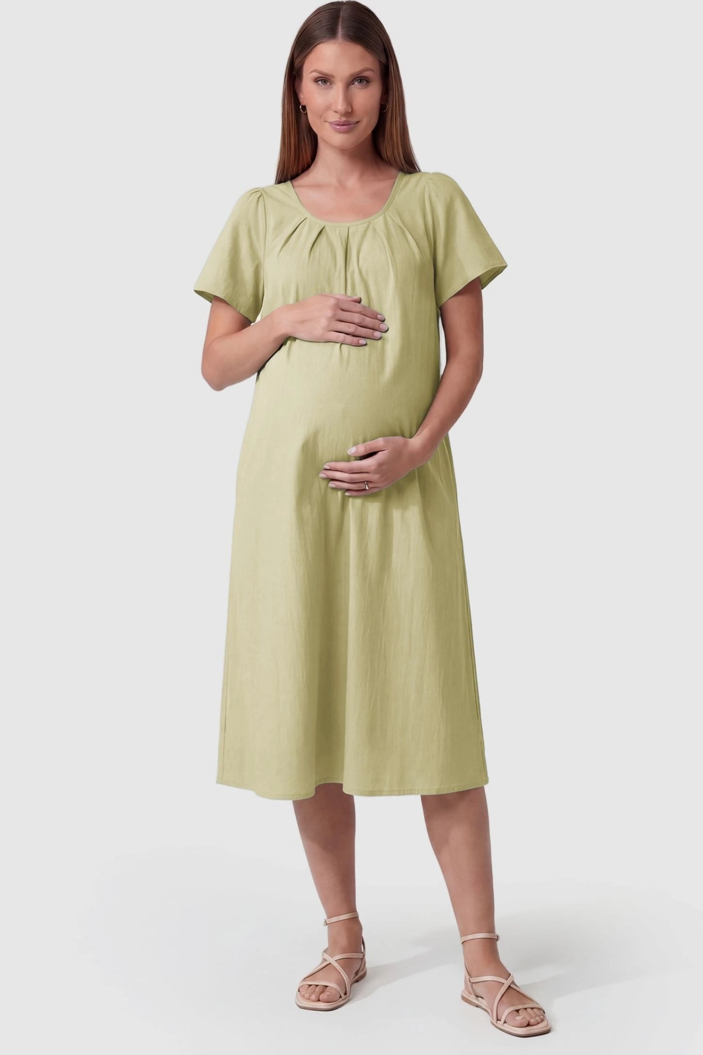 Pleated Round Neck Flowy Midi Maternity Dress Pleated Round Neck Flowy Midi Maternity Dress in Light Green featuring a pleated neckline on a pregnant model, front view.