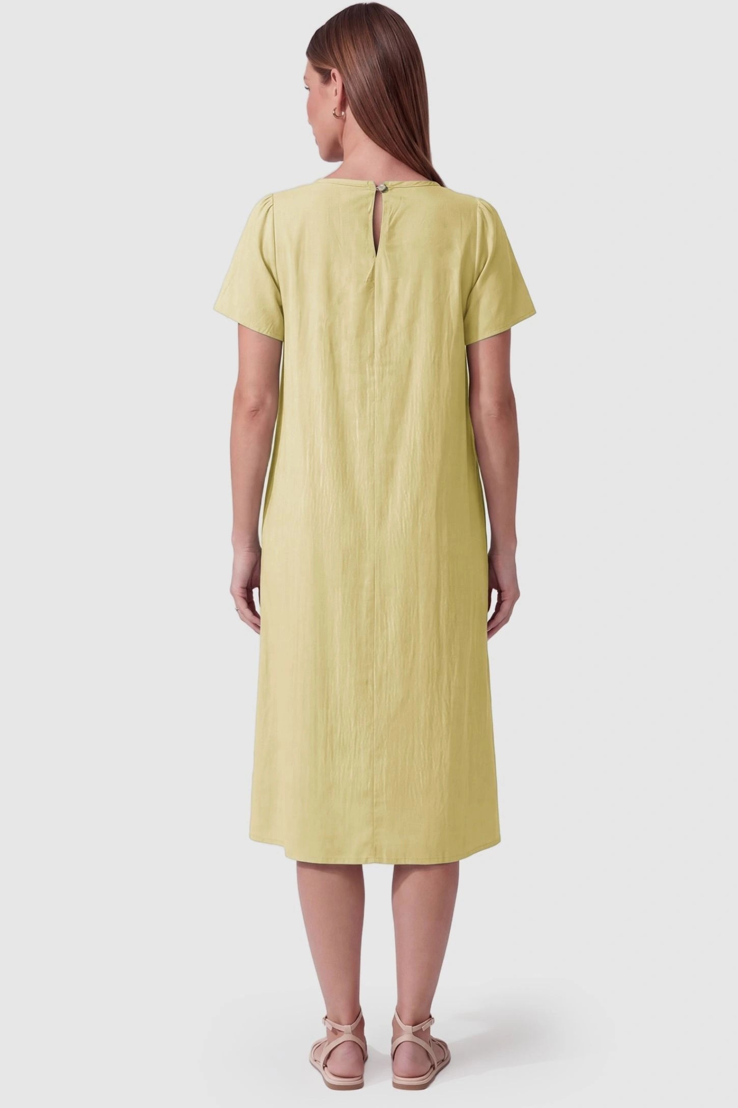 Pleated Round Neck Flowy Midi Maternity Dress Pleated Round Neck Flowy Midi Maternity Dress in Yellow featuring a keyhole back closure on a pregnant model, back view.