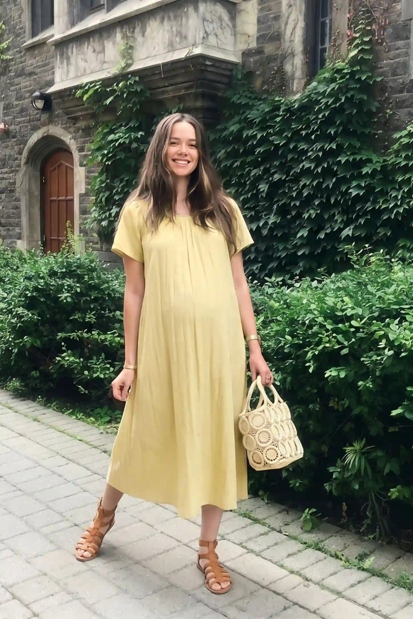 Pleated Round Neck Flowy Midi Maternity Dress Pleated Round Neck Flowy Midi Maternity Dress in Yellow featuring a pleated neckline on a pregnant model, front view.