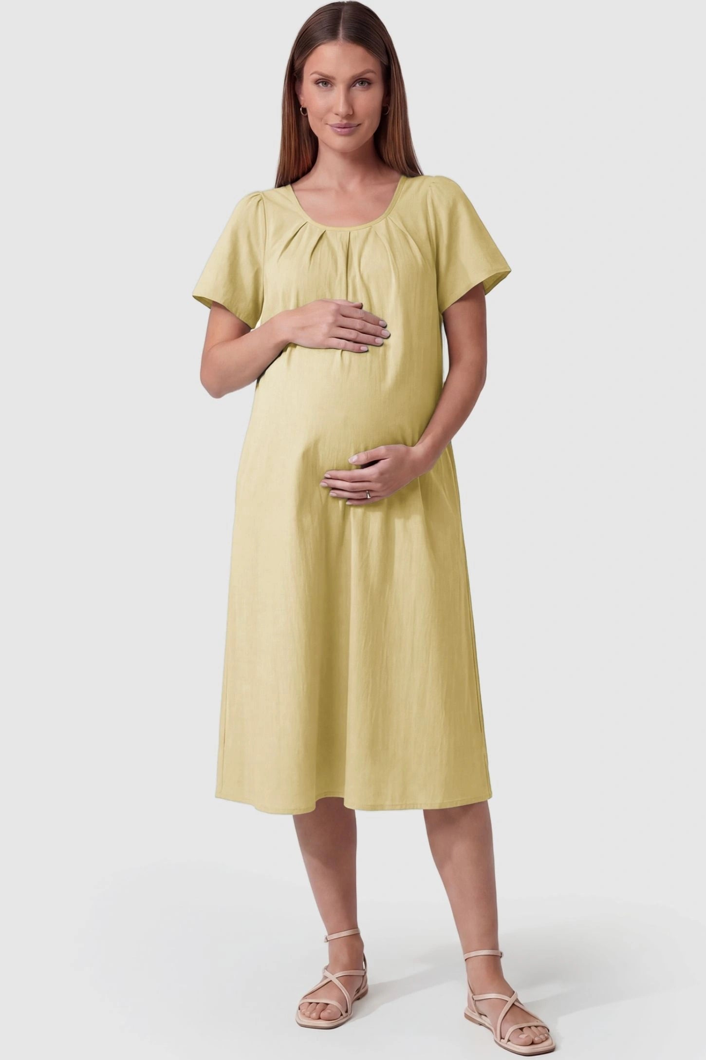 Pleated Round Neck Flowy Midi Maternity Dress Pleated Round Neck Flowy Midi Maternity Dress in Yellow featuring a pleated neckline on a pregnant model, front view.