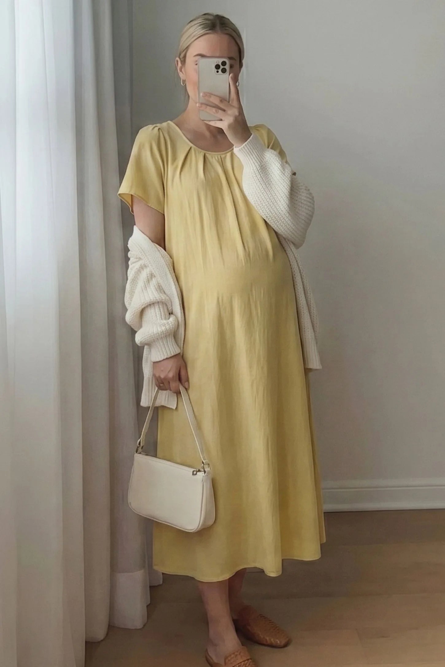 Pleated Round Neck Flowy Midi Maternity Dress Pleated Round Neck Flowy Midi Maternity Dress in Yellow featuring comfortable short sleeves on a pregnant model, mirror selfie.