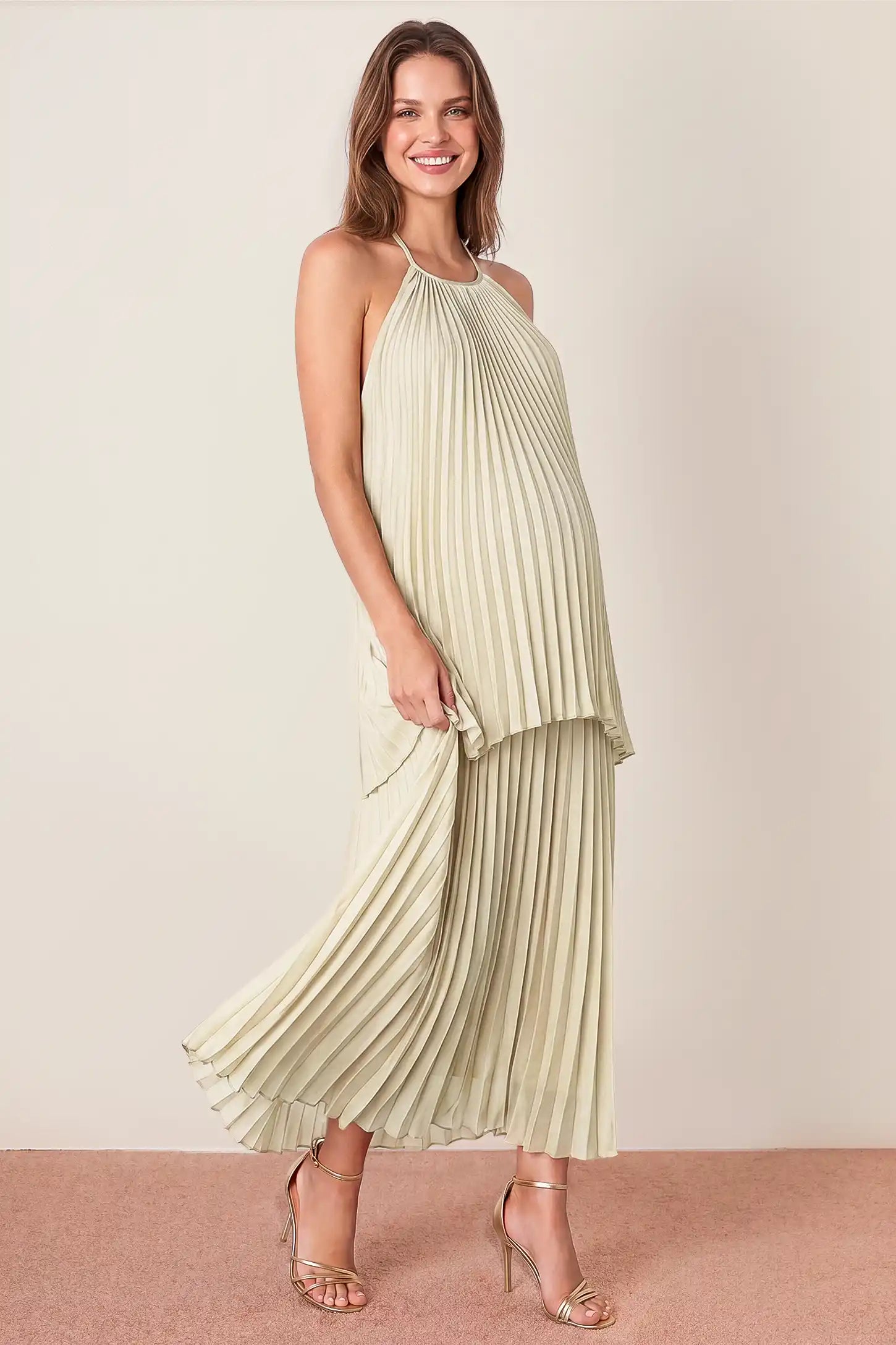 Pleated Tiered Halter Maxi Maternity Gown Pleated Tiered Halter Maxi Maternity Gown in Soft Sage featuring a halter neckline, front view on a pregnant model.