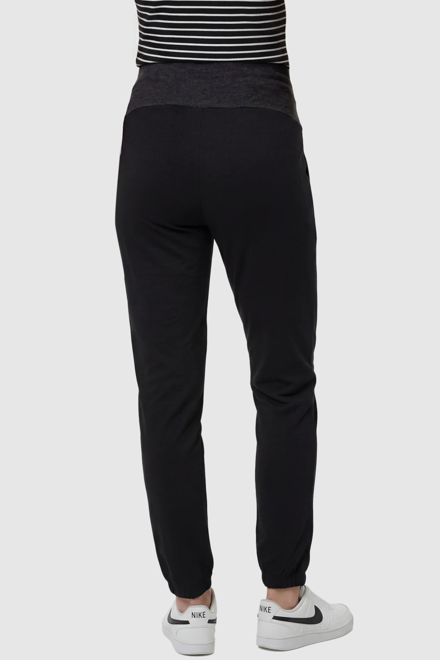 Full Panel Pocketed Maternity Jogger Pants Full Panel Pocketed Maternity Jogger Pants in Black featuring lightweight, slight stretch fabric on a pregnant model, back view.