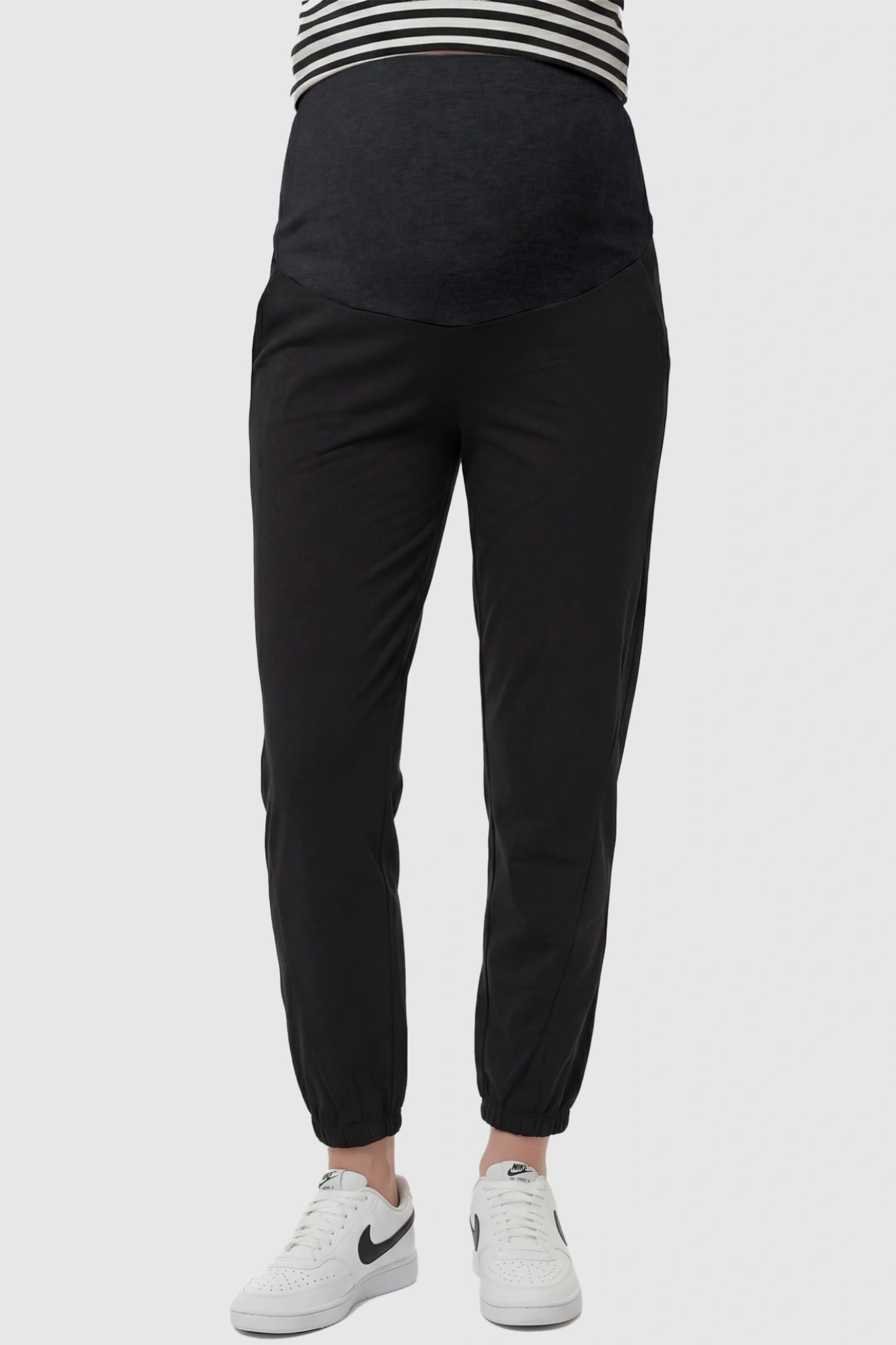 Full Panel Pocketed Maternity Jogger Pants in Black featuring a jersey belly panel on a pregnant model, front view.